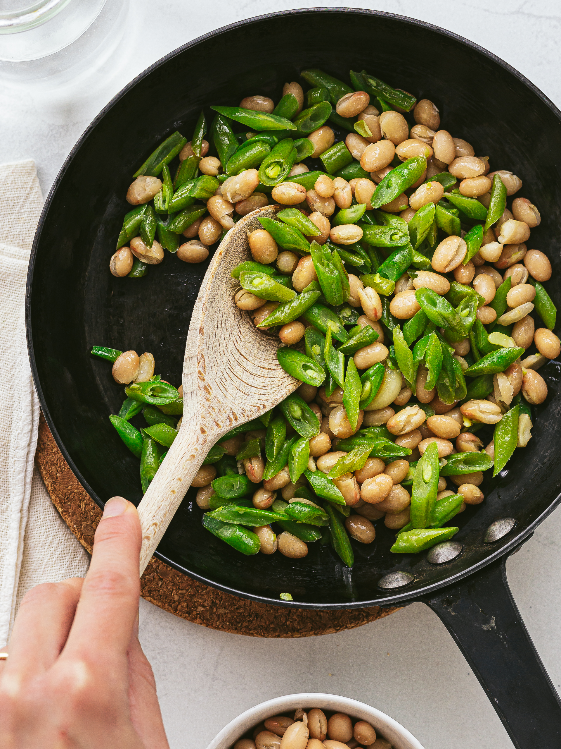 cannellini beans and green beans cooking in a skillet