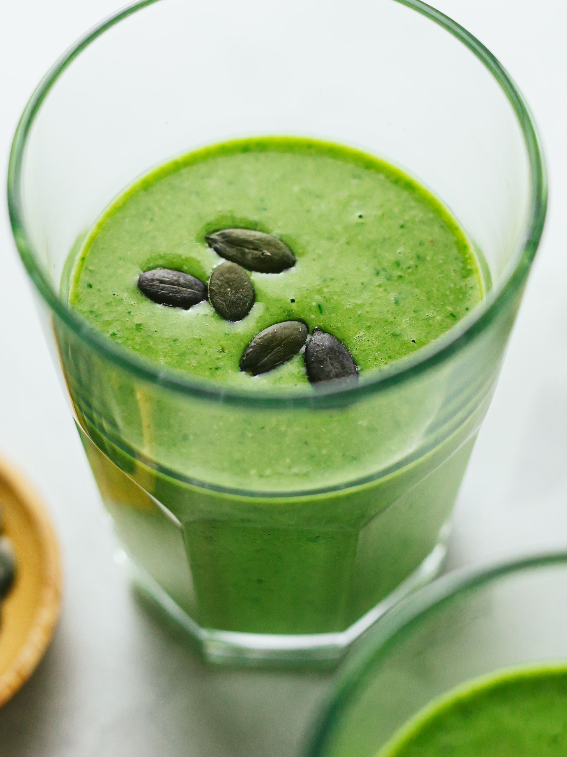 green pumpkin seed smoothie in a glass