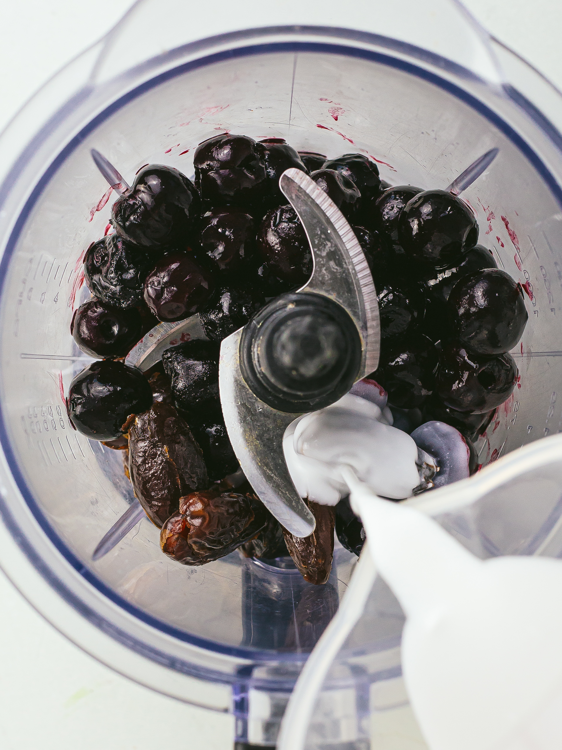 blender with dates, frozen cherries and coconut milk