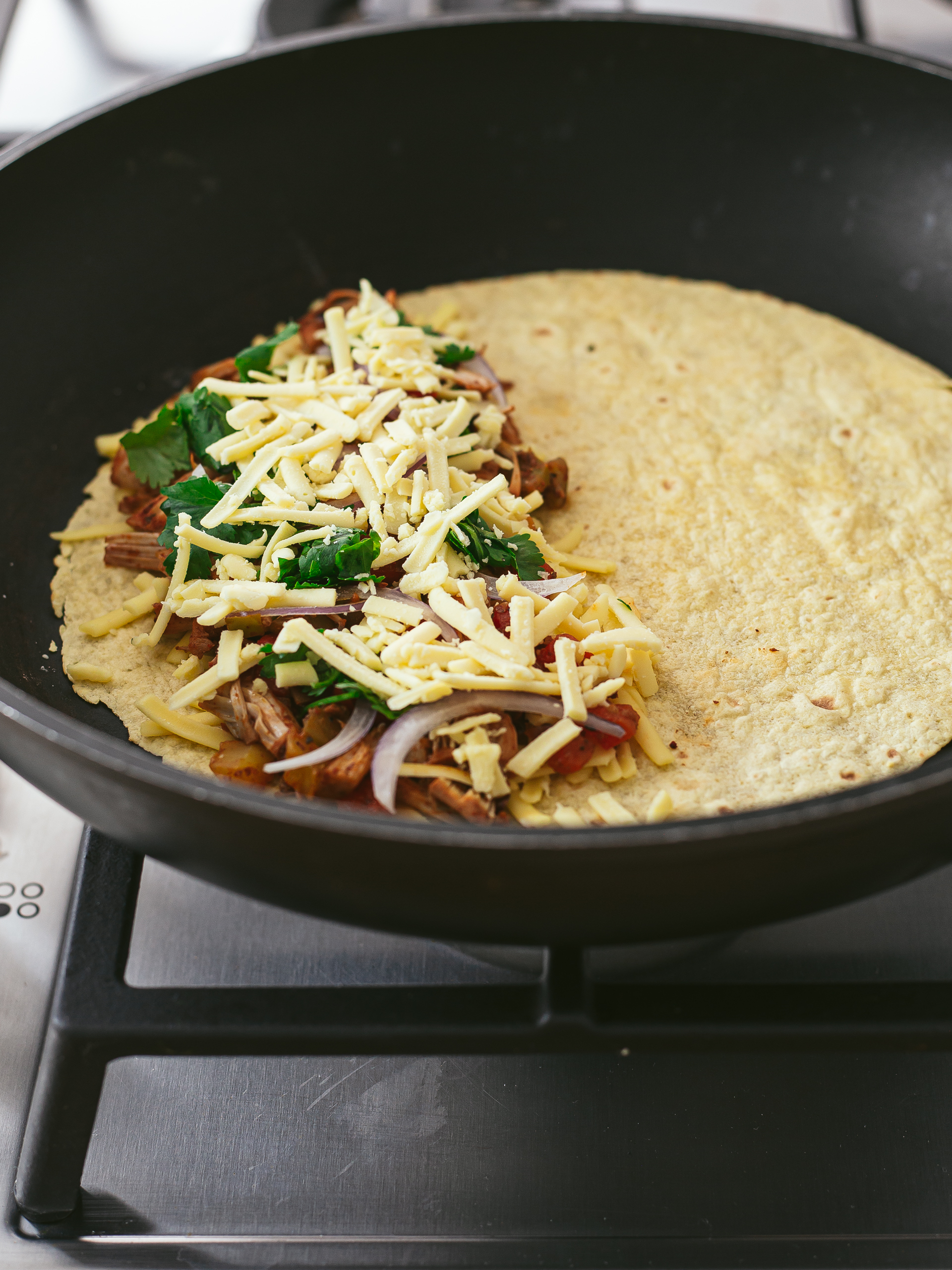 tortilla topped with jackfruit filling and vegan cheese