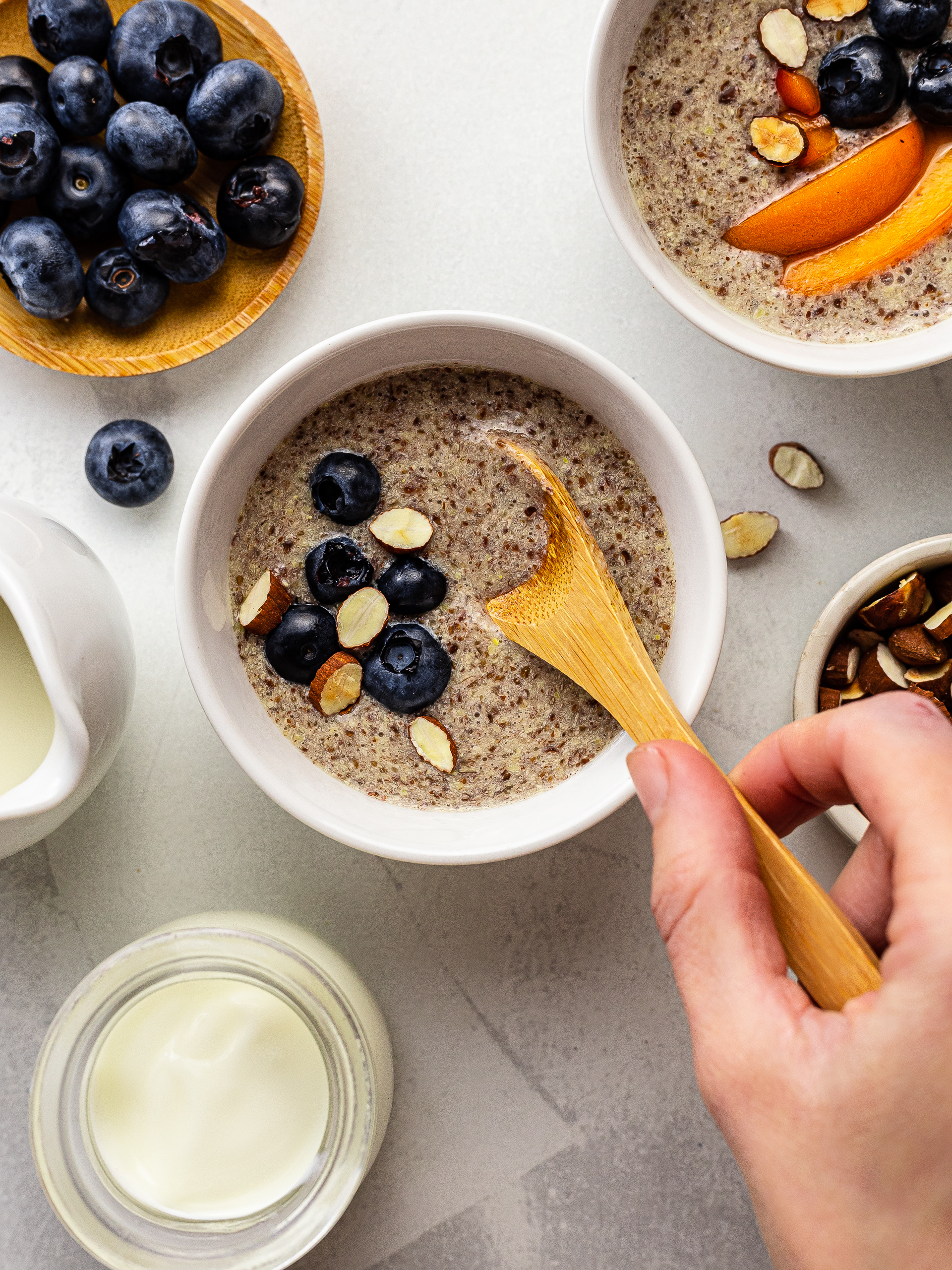 flaxseed porridge in a cup with blueberries and almonds