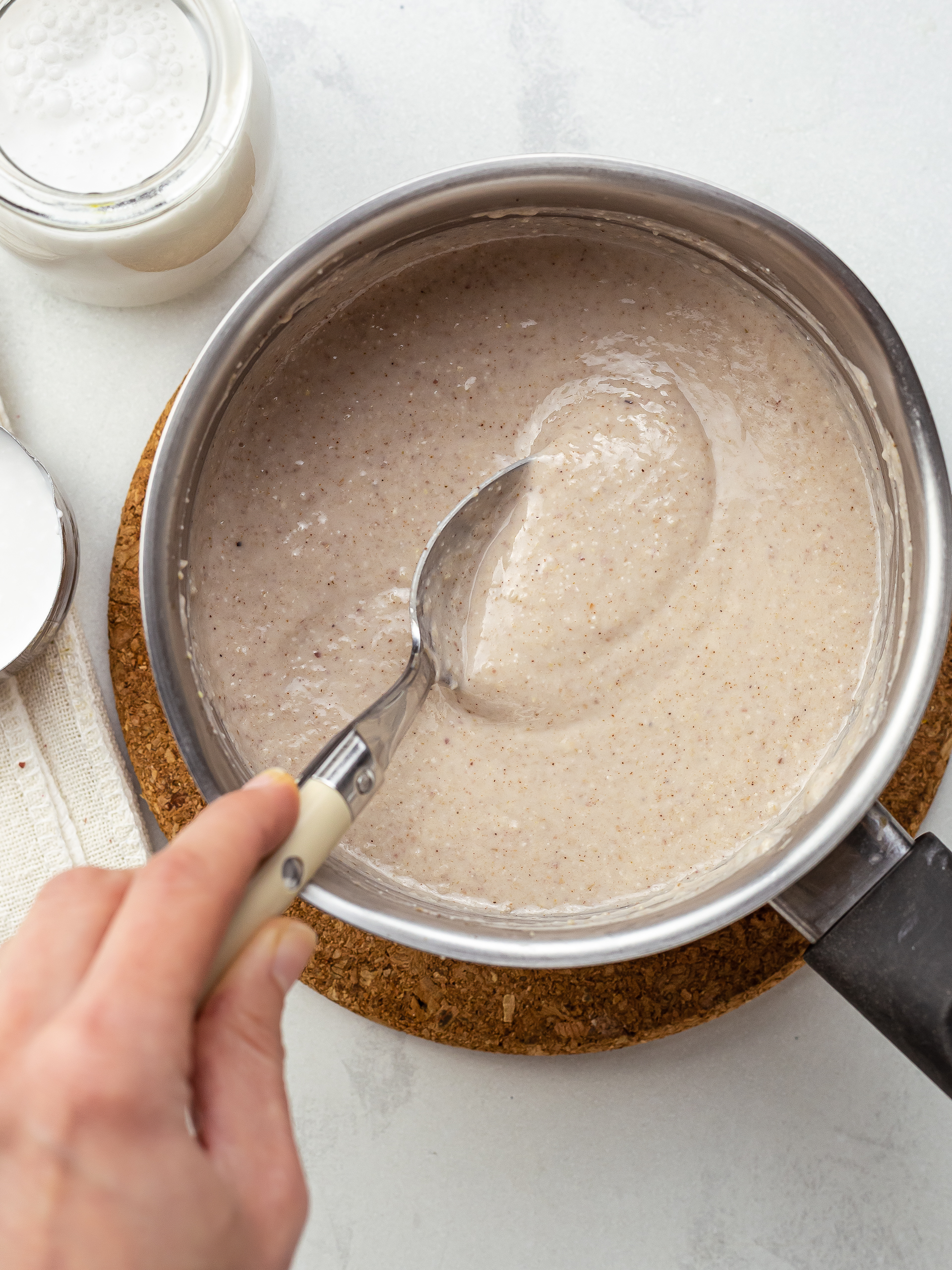 creamy jamaican peanut porridge with oats and coconut milk in a pot