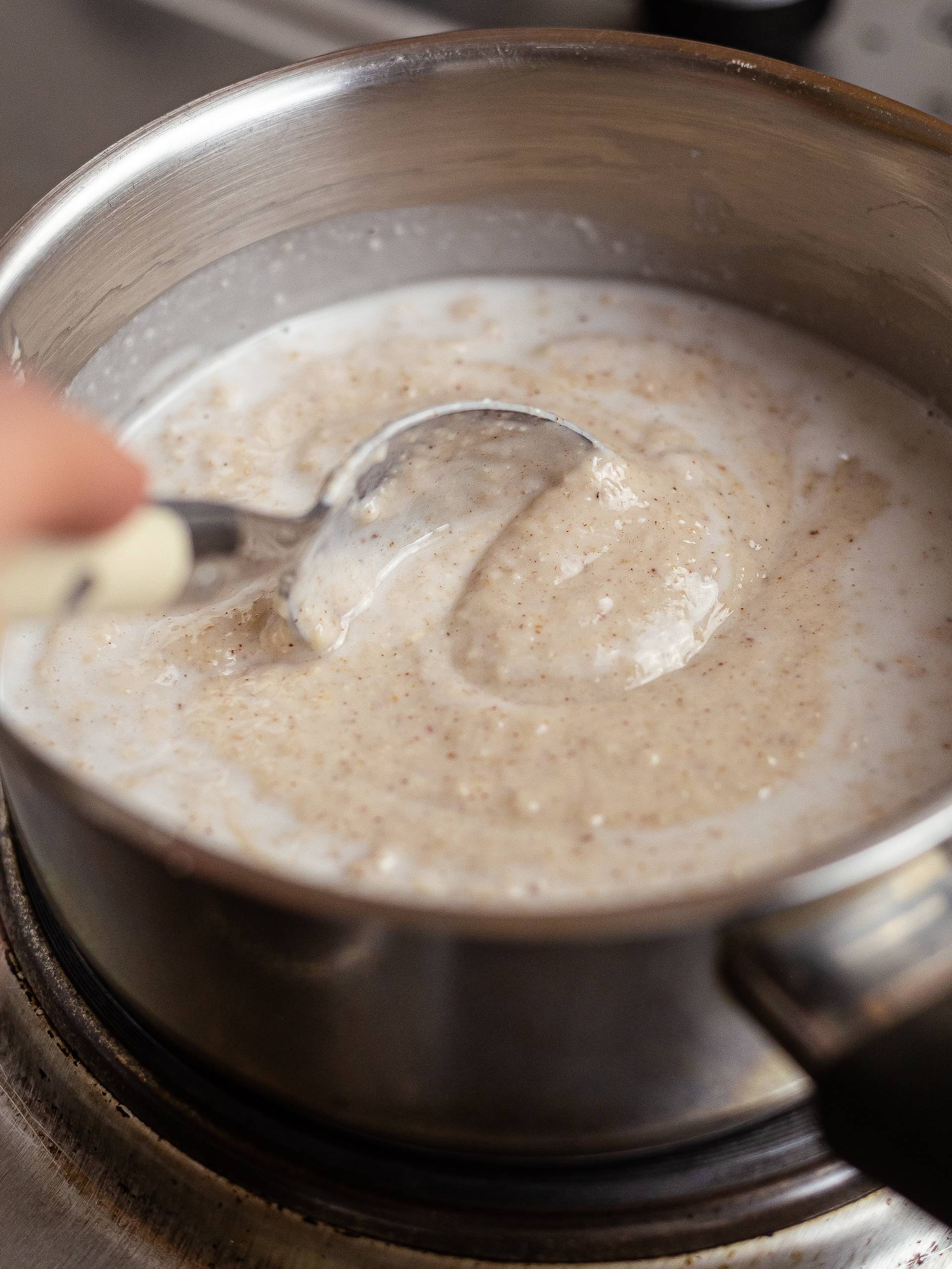 peanut porridge cooking in a pot with coconut milk