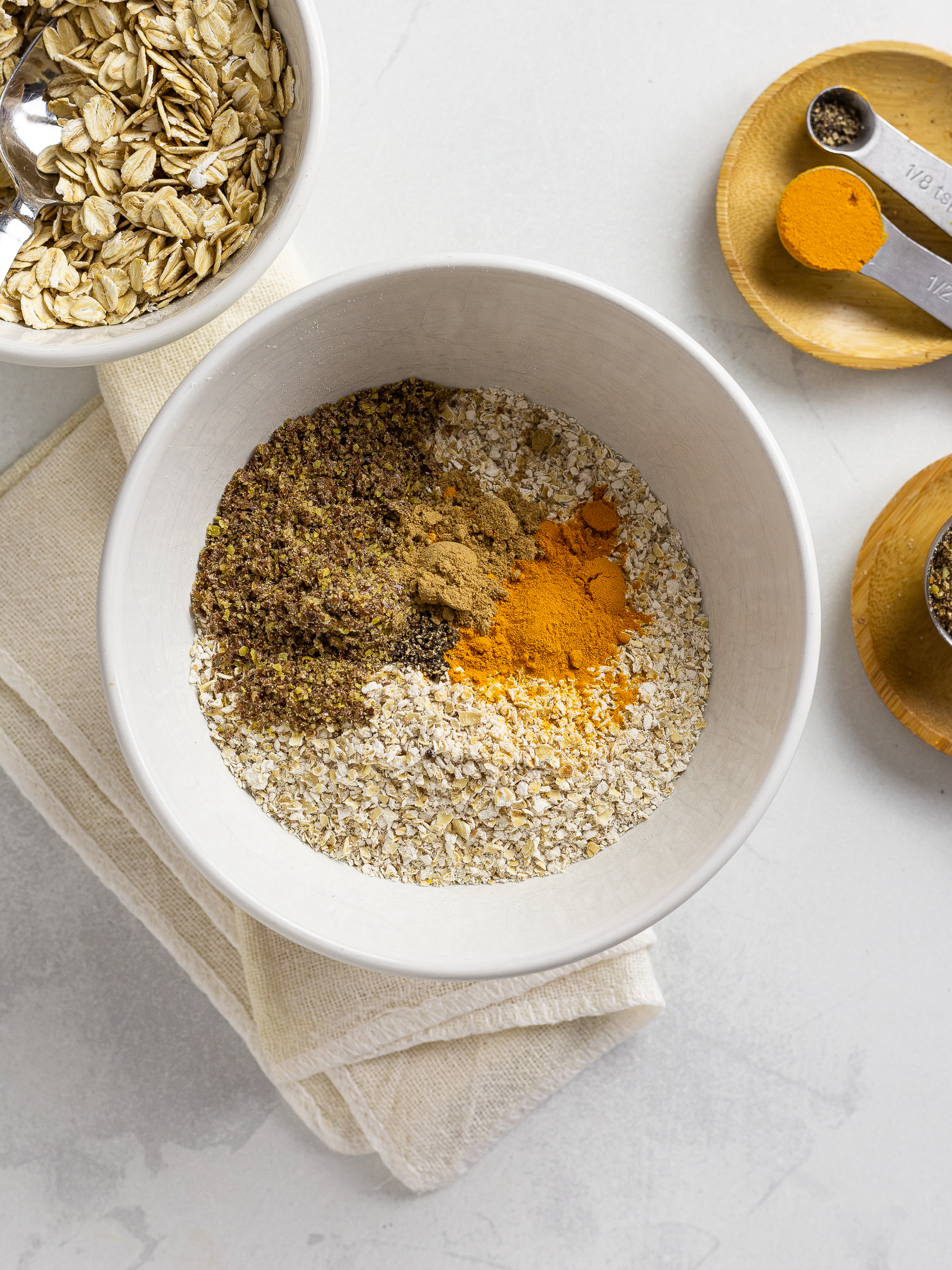 Bowl of ground oats, turmeric, ginger and flaxseed