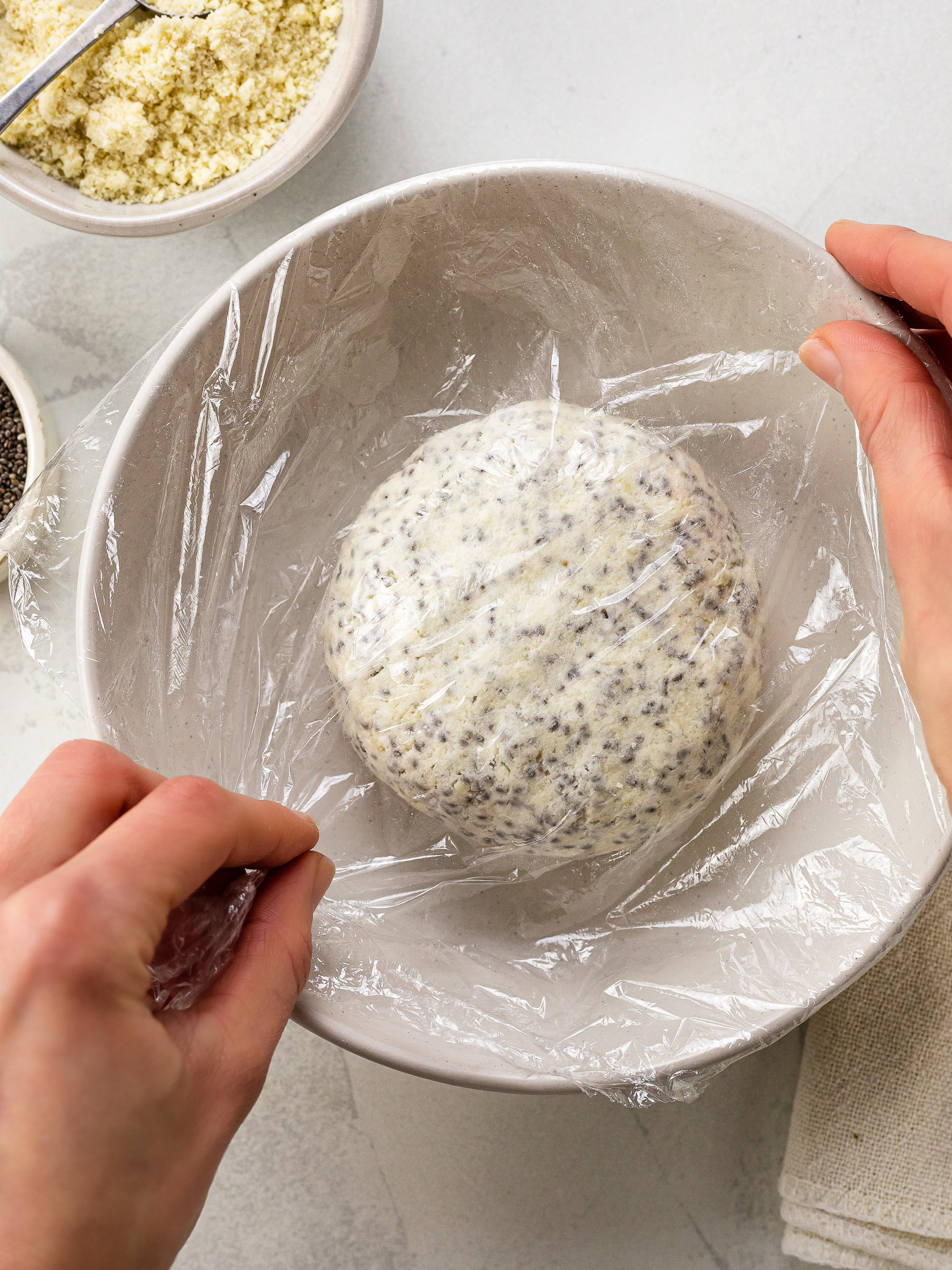 chia seed cracker dough covered with cling film