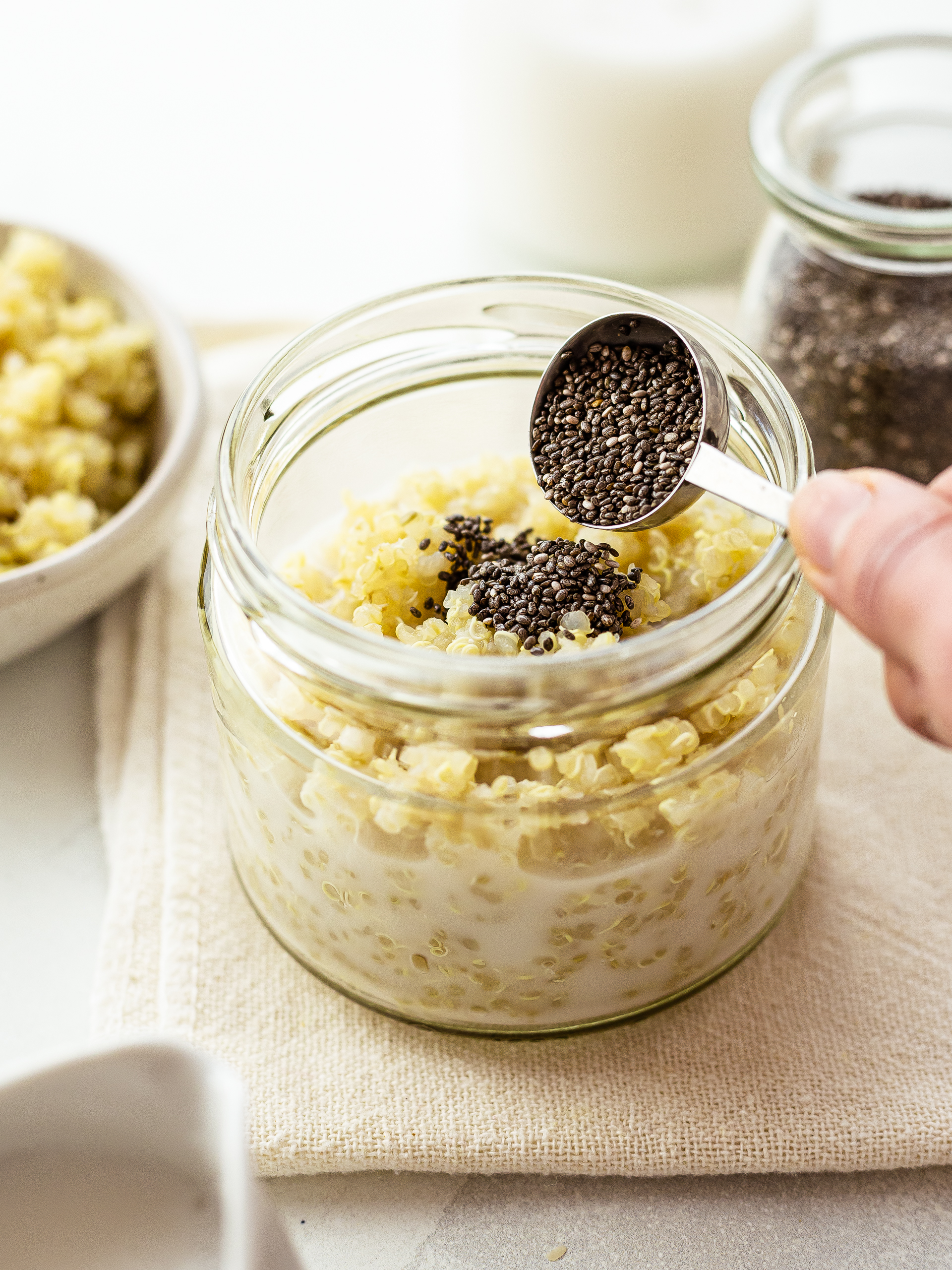 cooked quinoa with chia seeds and milk in a jar