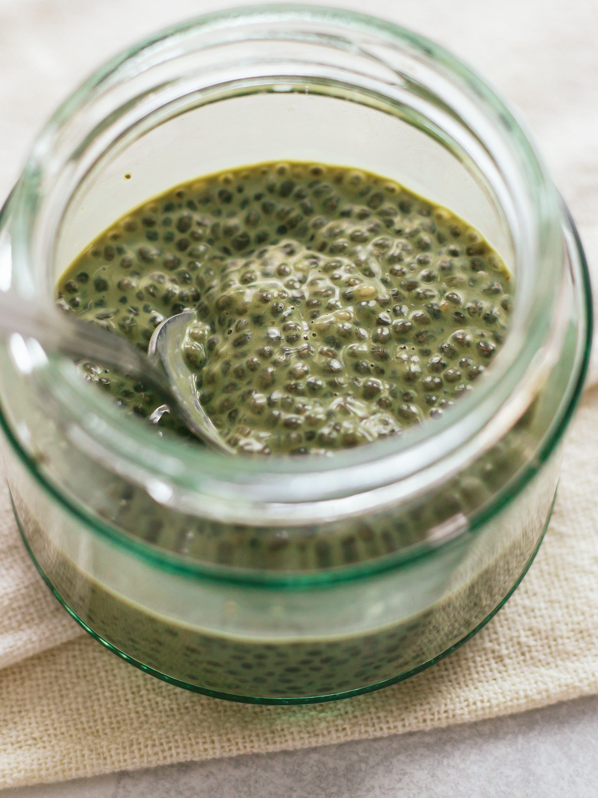 chia seeds soaked in matcha milk in a jar