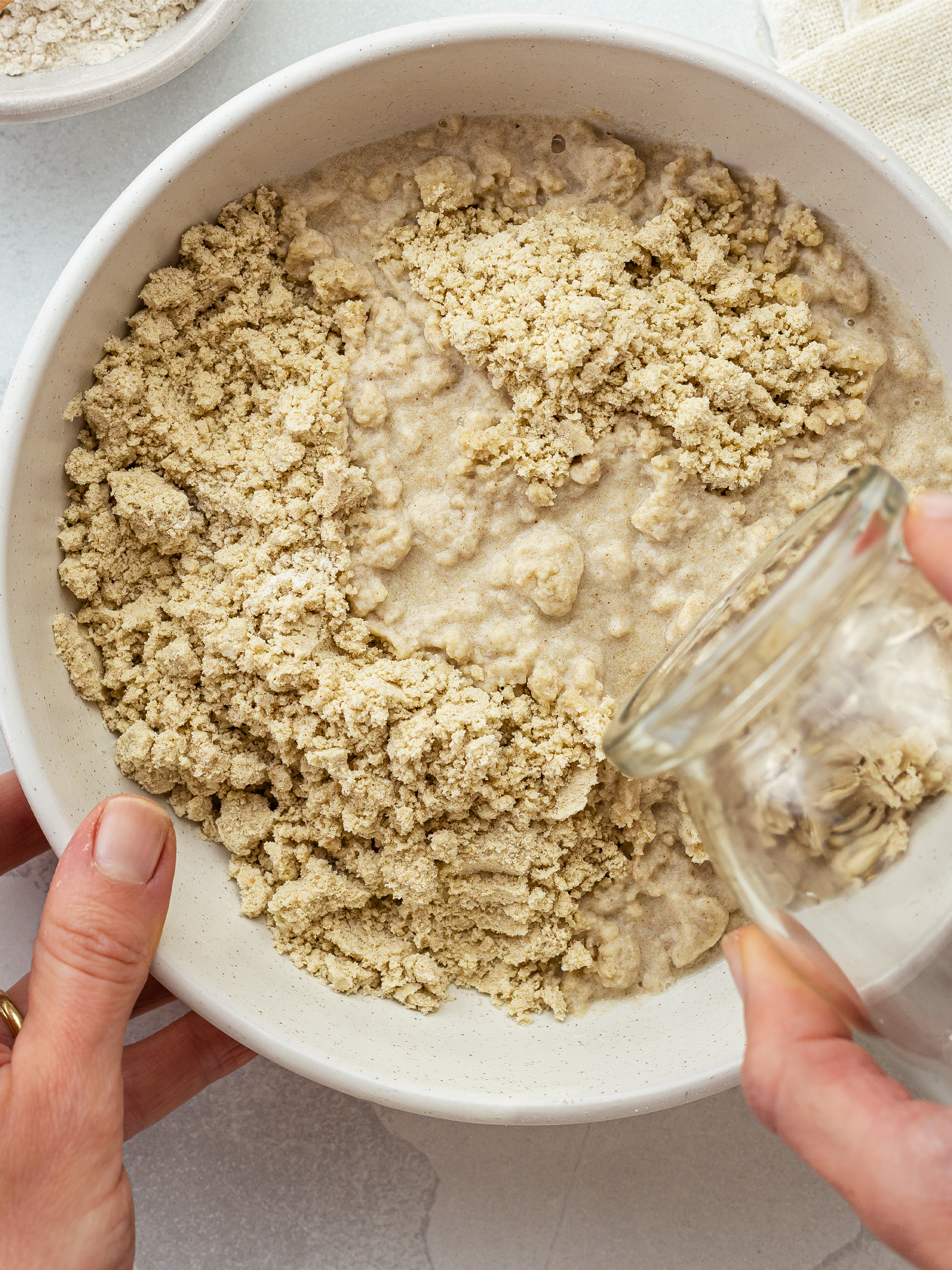 buckwheat flour and water in a bowl for cracker dough