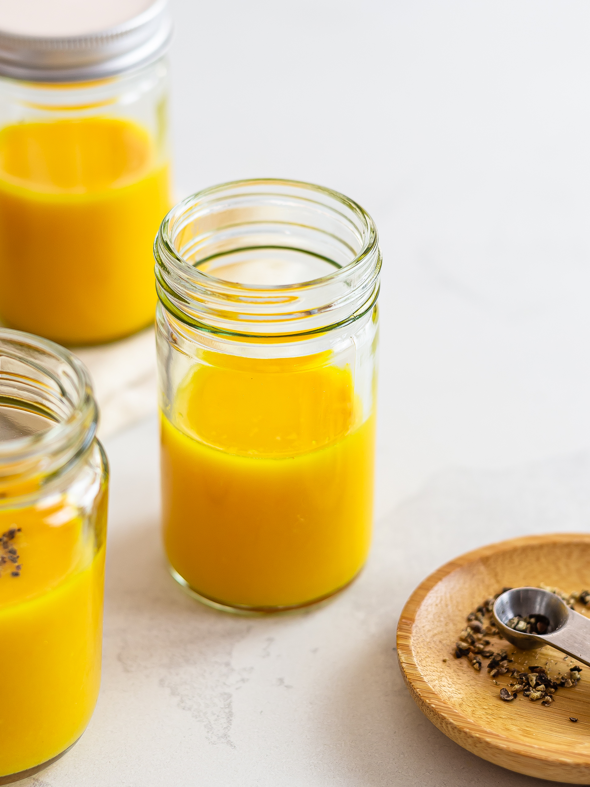 Turmeric ginger lemon juice in jars for one serving