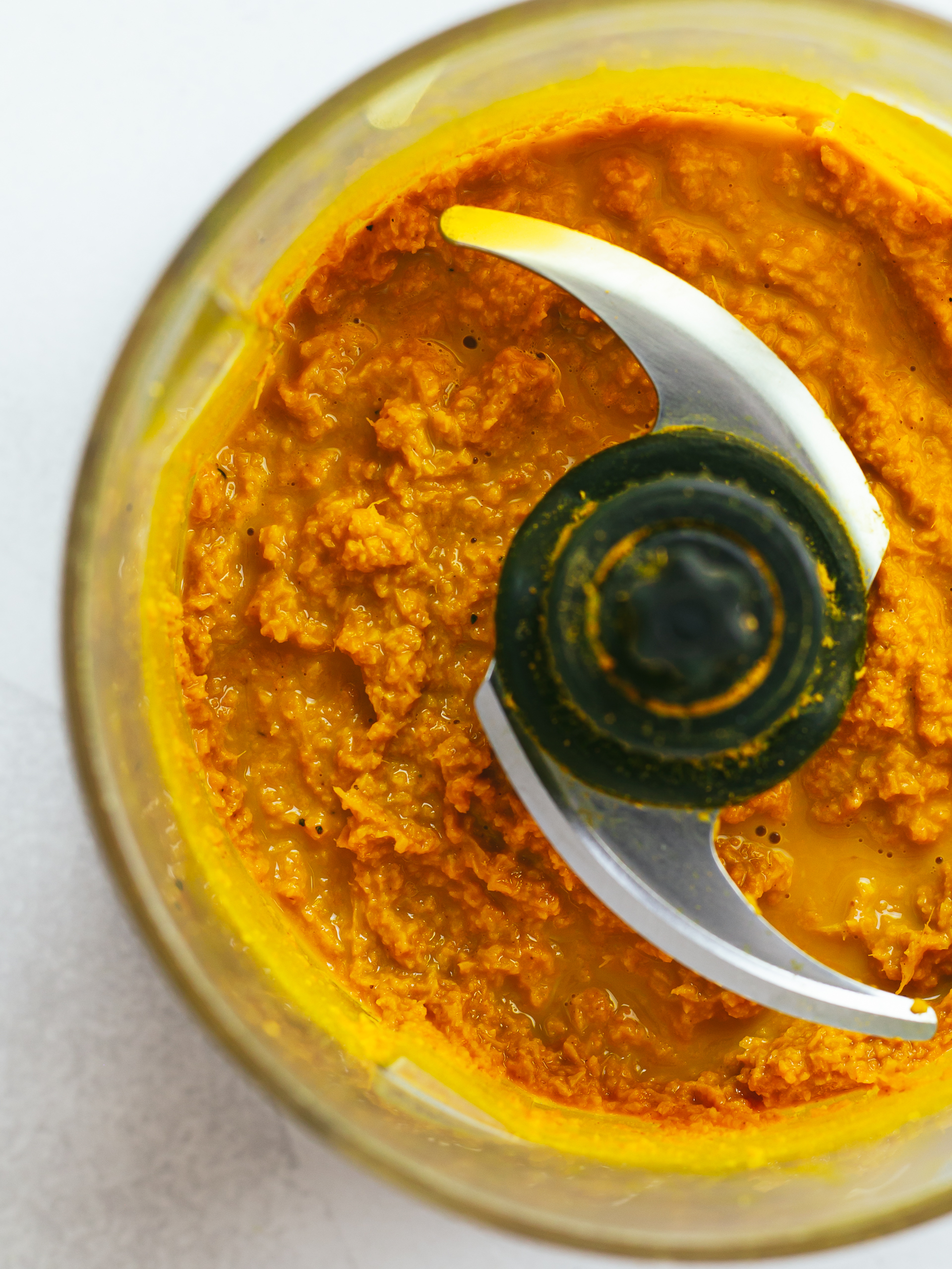 raw ginger and turmeric powder golden paste in a blender