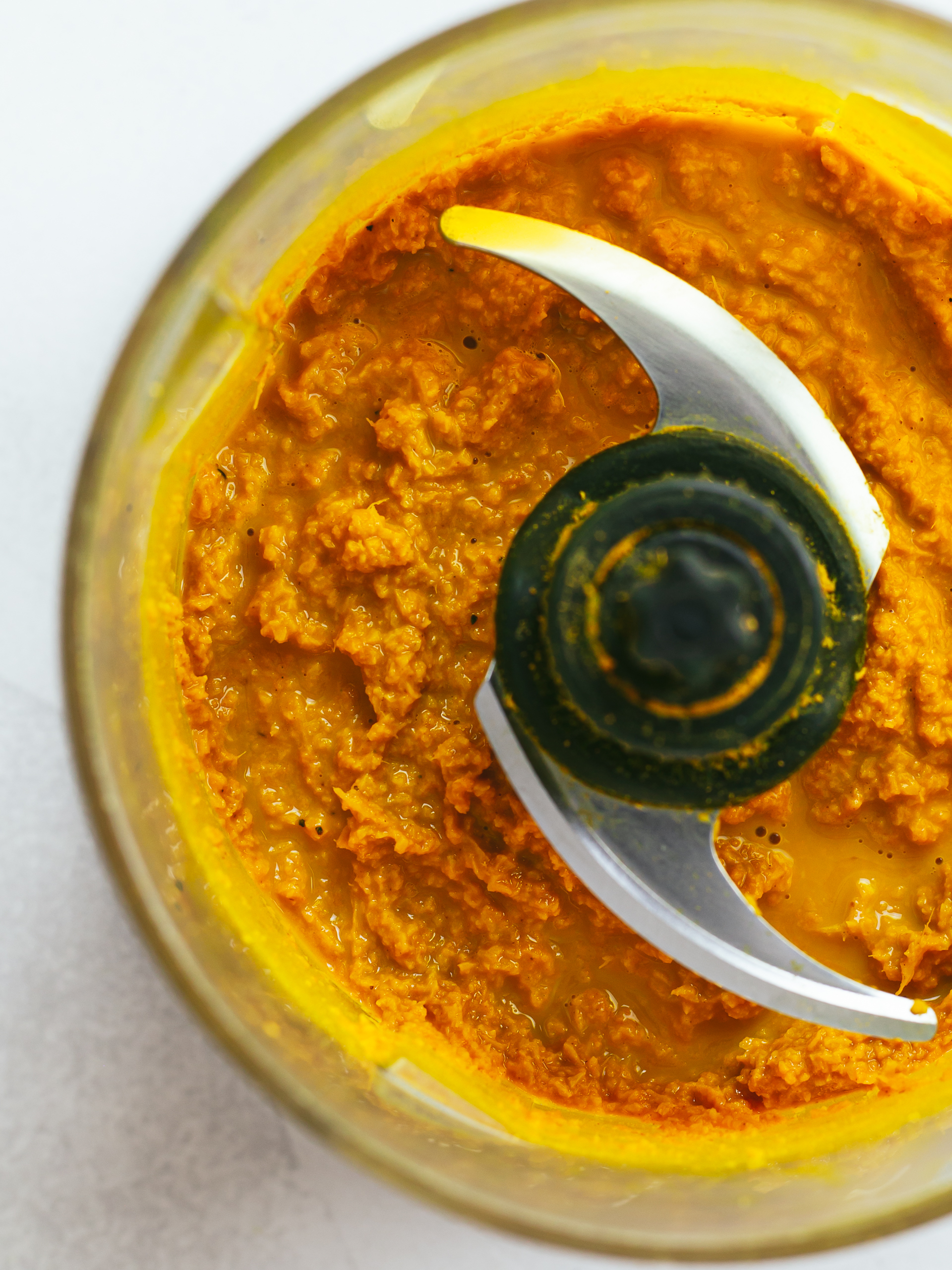 Raw ginger and turmeric powder to a golden paste in a blender