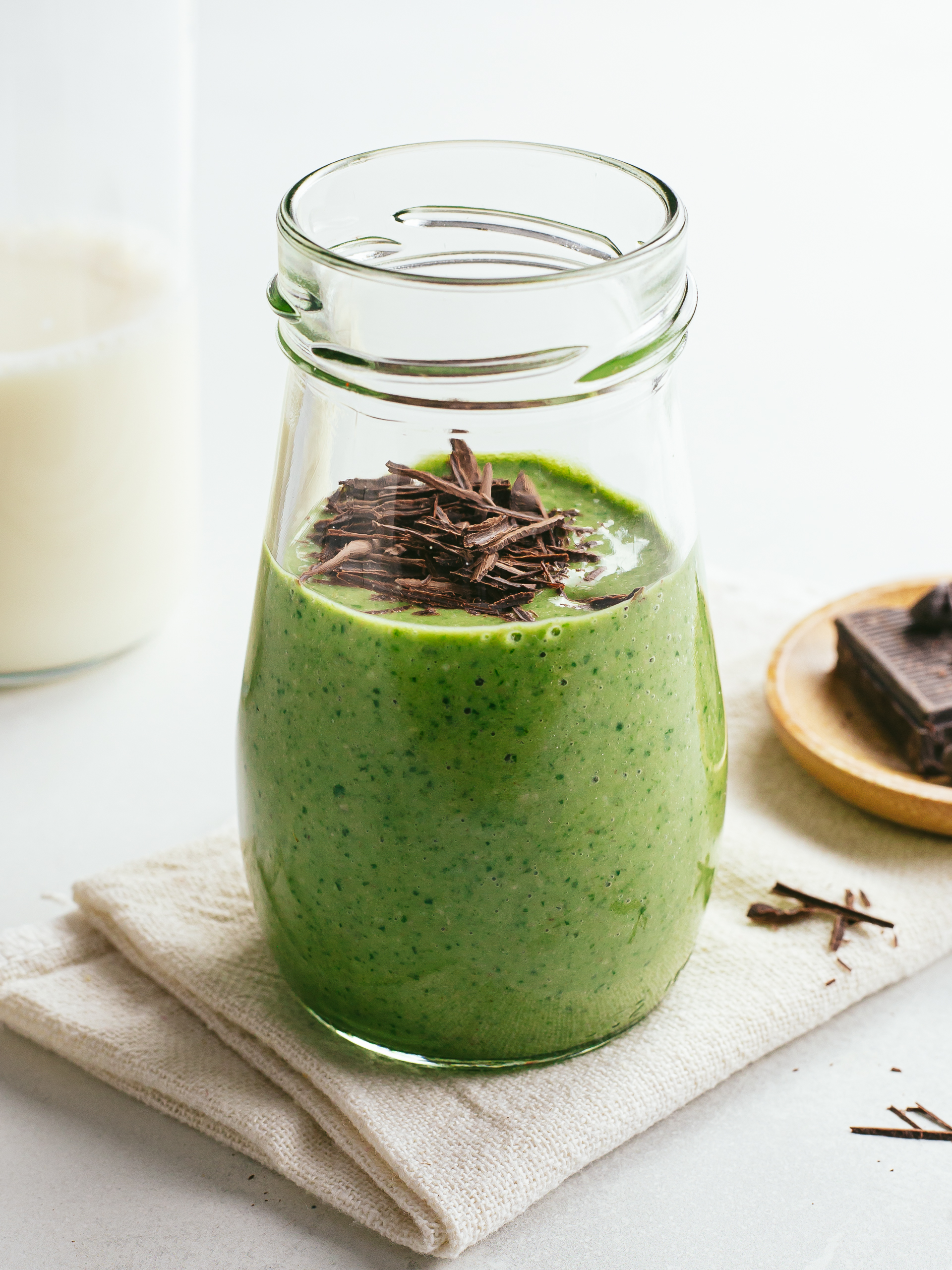 iron-boosting spinach smoothie in a jar with dark chocolate shavings