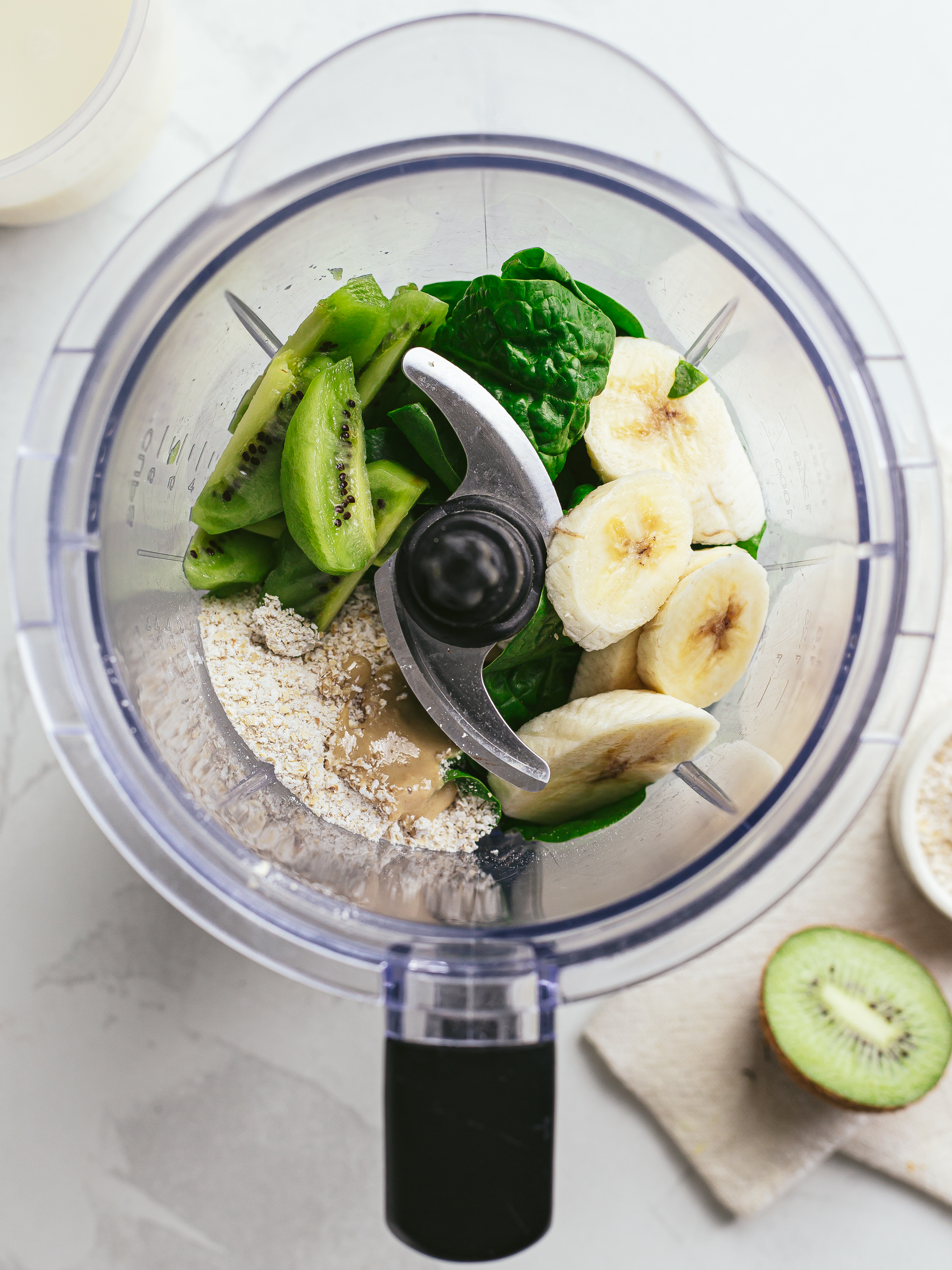 spinach kiwi oats banana and sesame paste in a blender