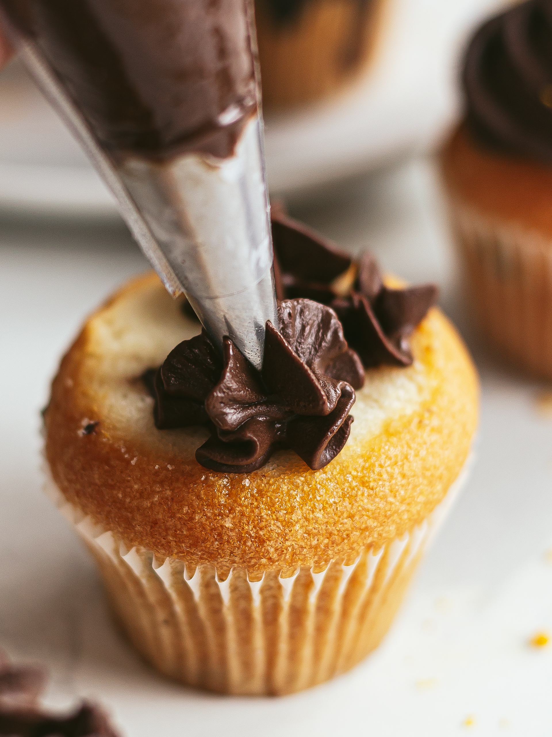 orange chocolate ganache piped on a muffin