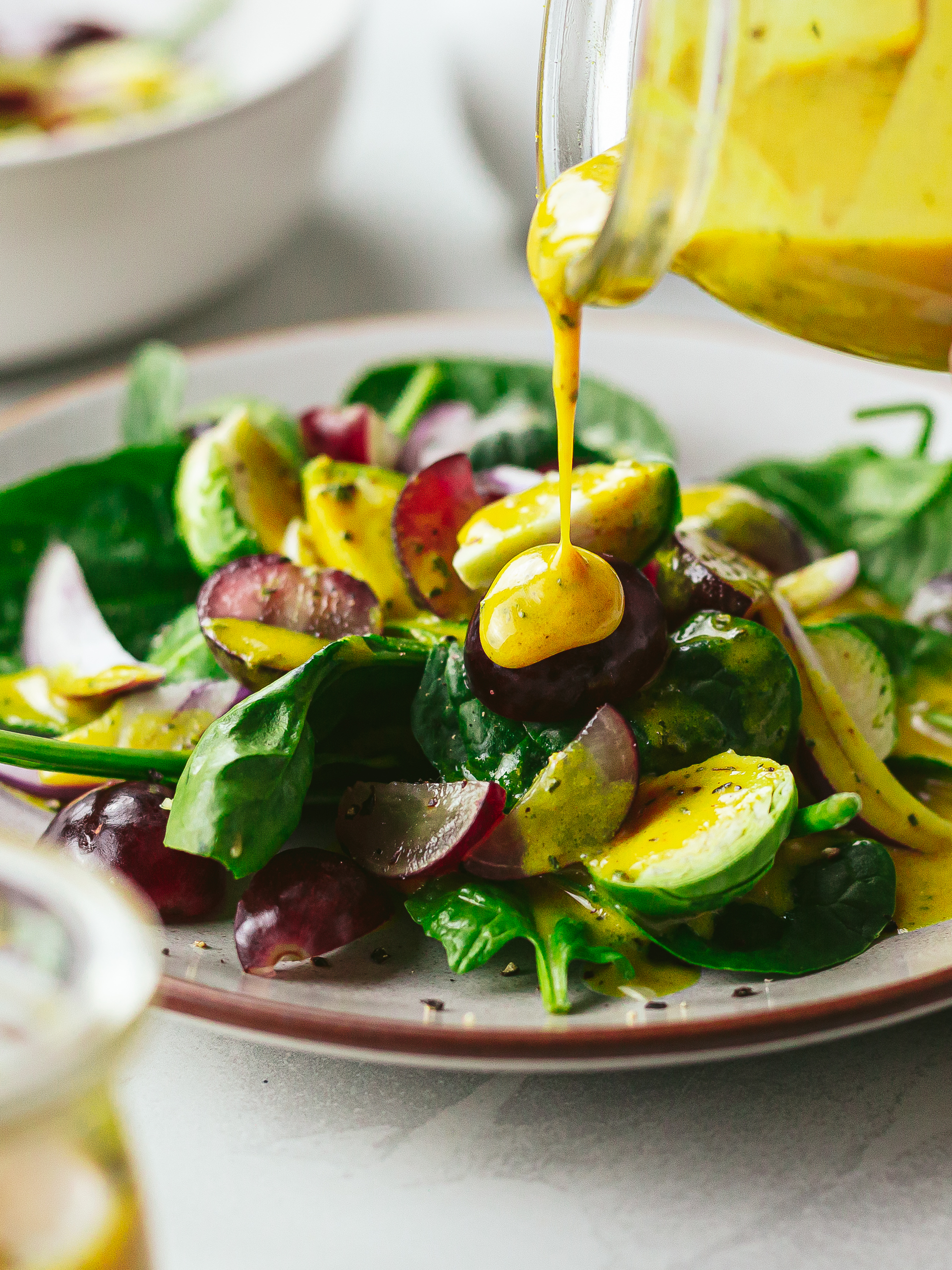 anti-inflammatory ginger turmeric dressing poured over a healthy salad