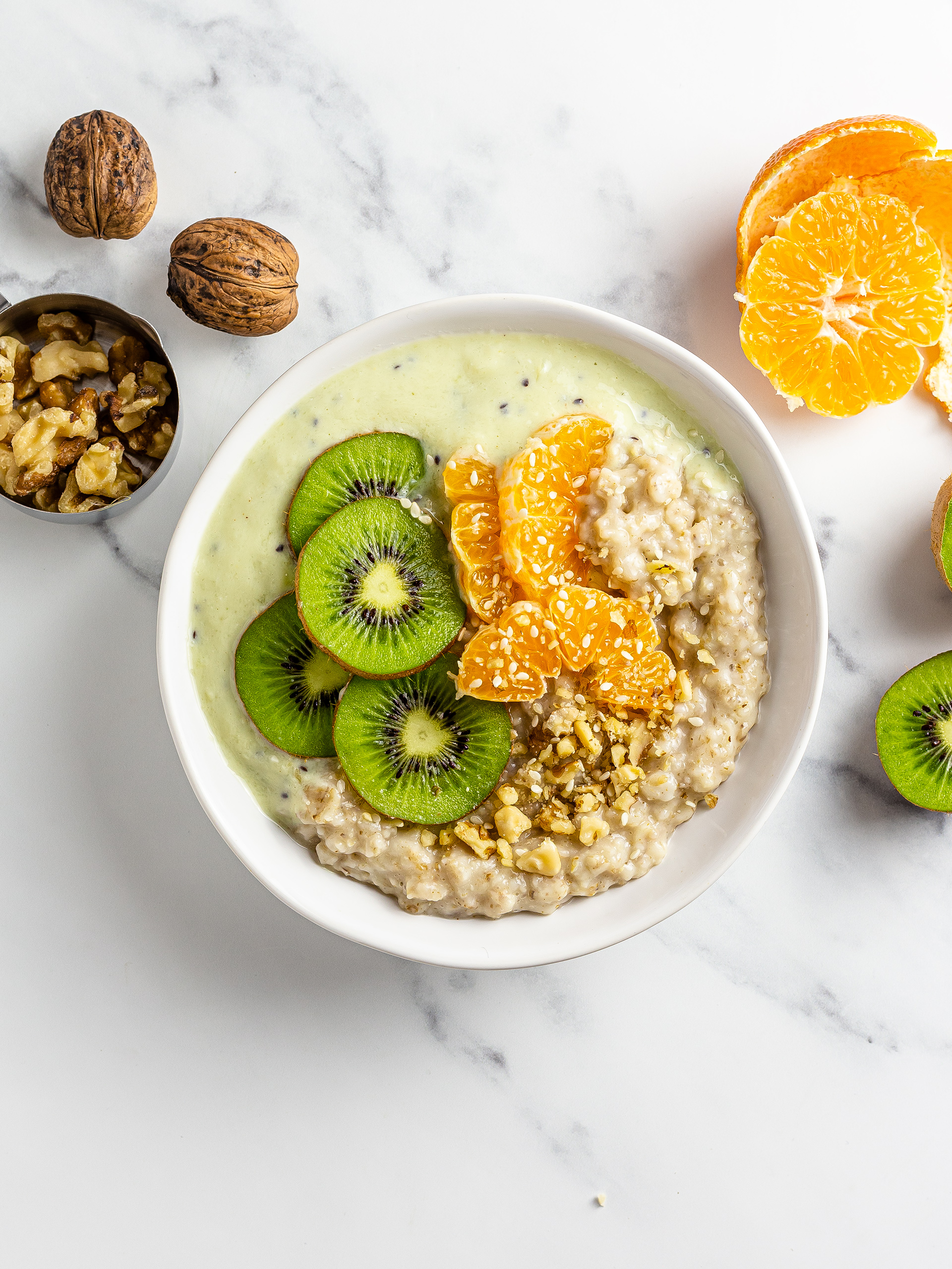 Tofu oatmeal topped with kiwi tangerines and walnuts