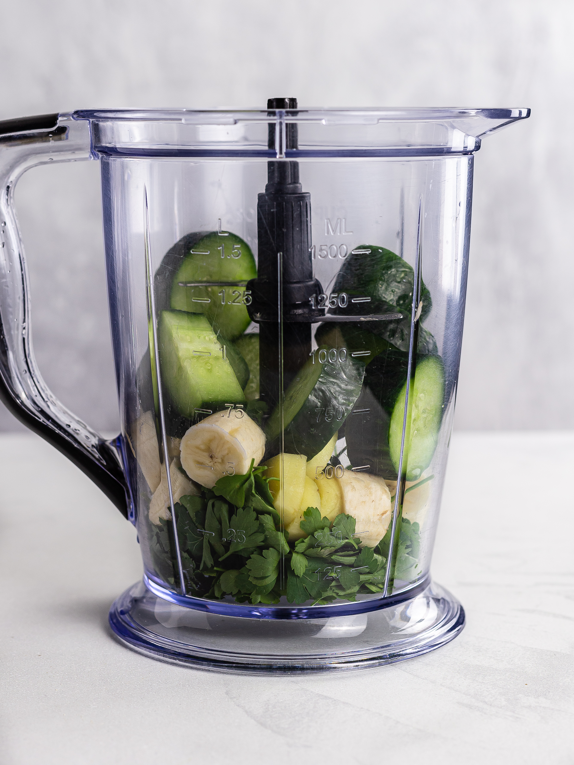 parsley, cucumber, ginger and banana in a blender