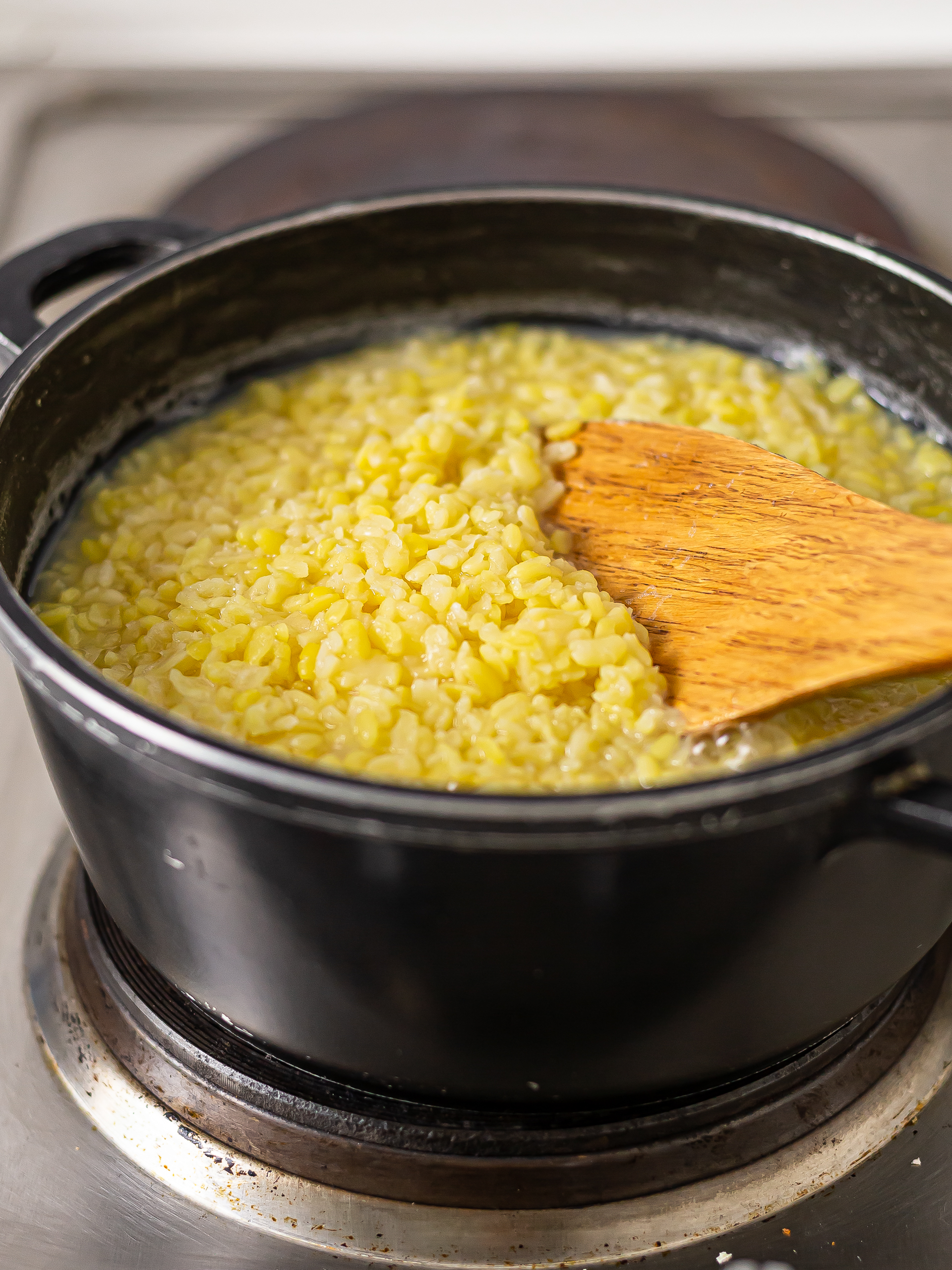 yellow mung beans cooking in a pot to make sweet bean paste