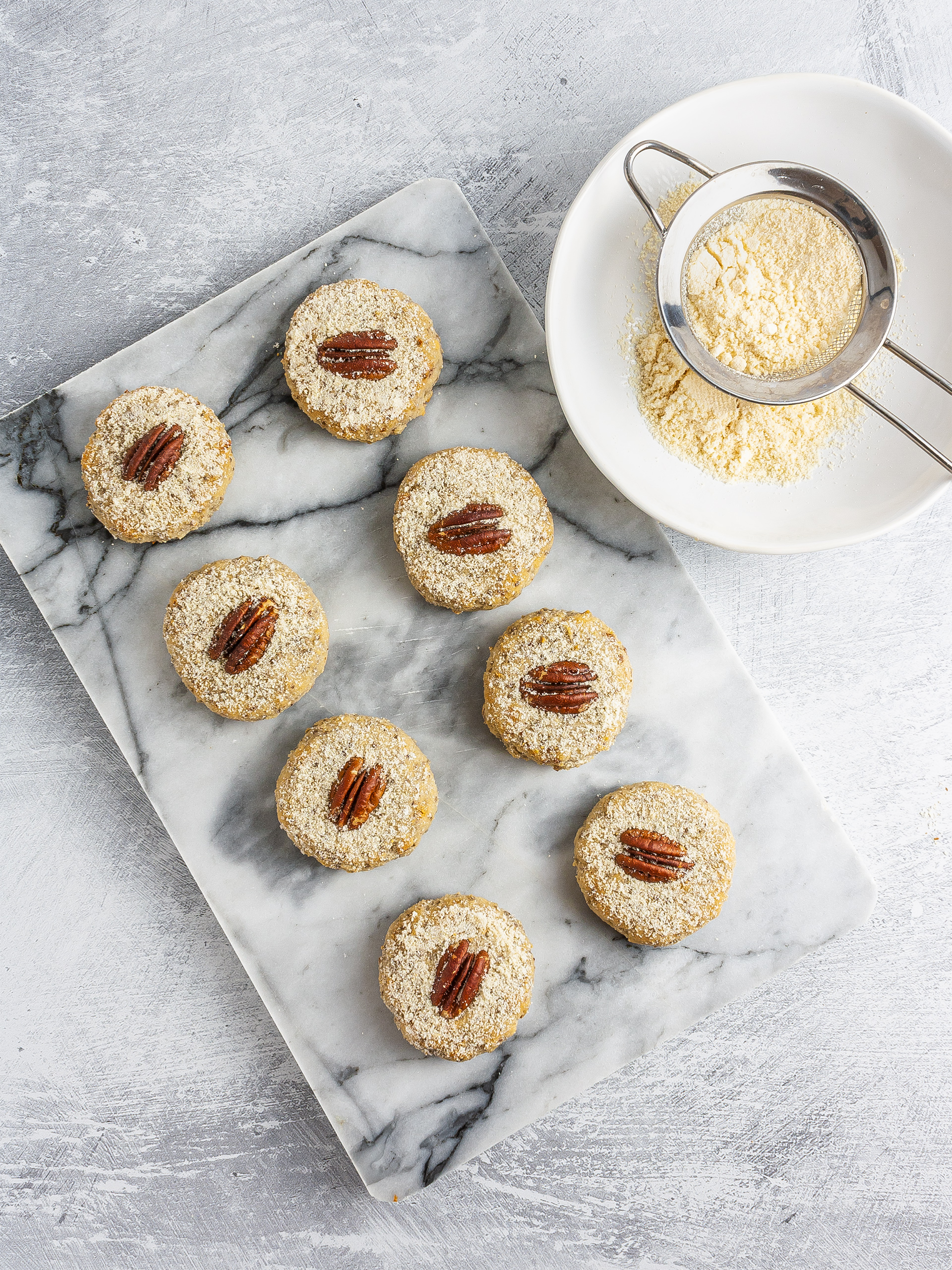 Baked pecan sandies dusted with almond meal