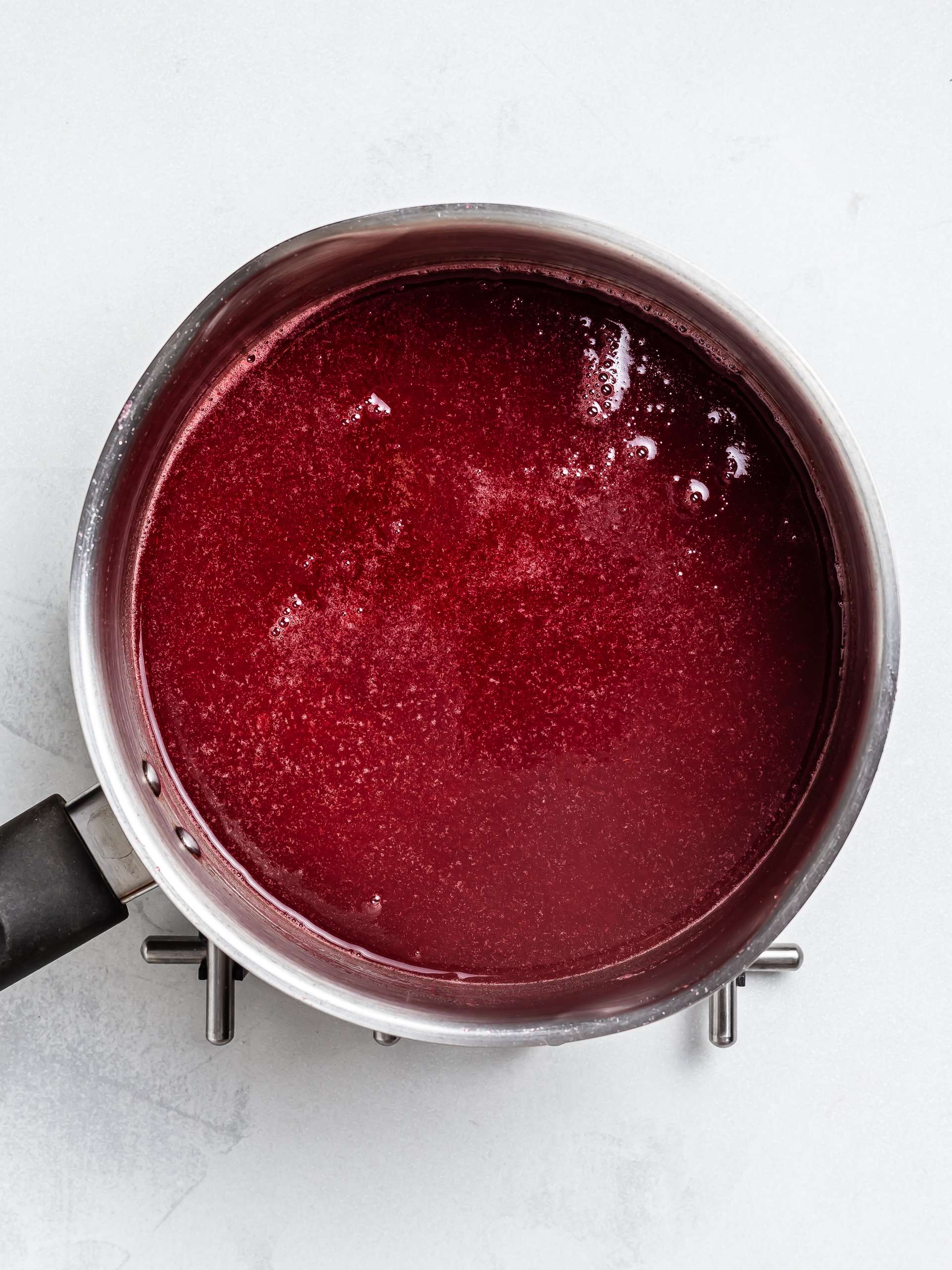 apple raspberry jam cooking in a pot