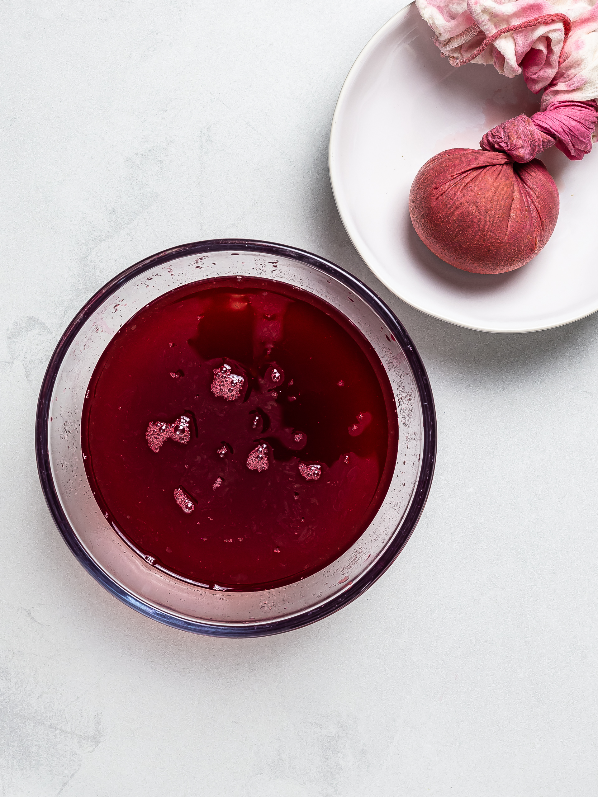 filtered raspberry juice with a cheesecloth