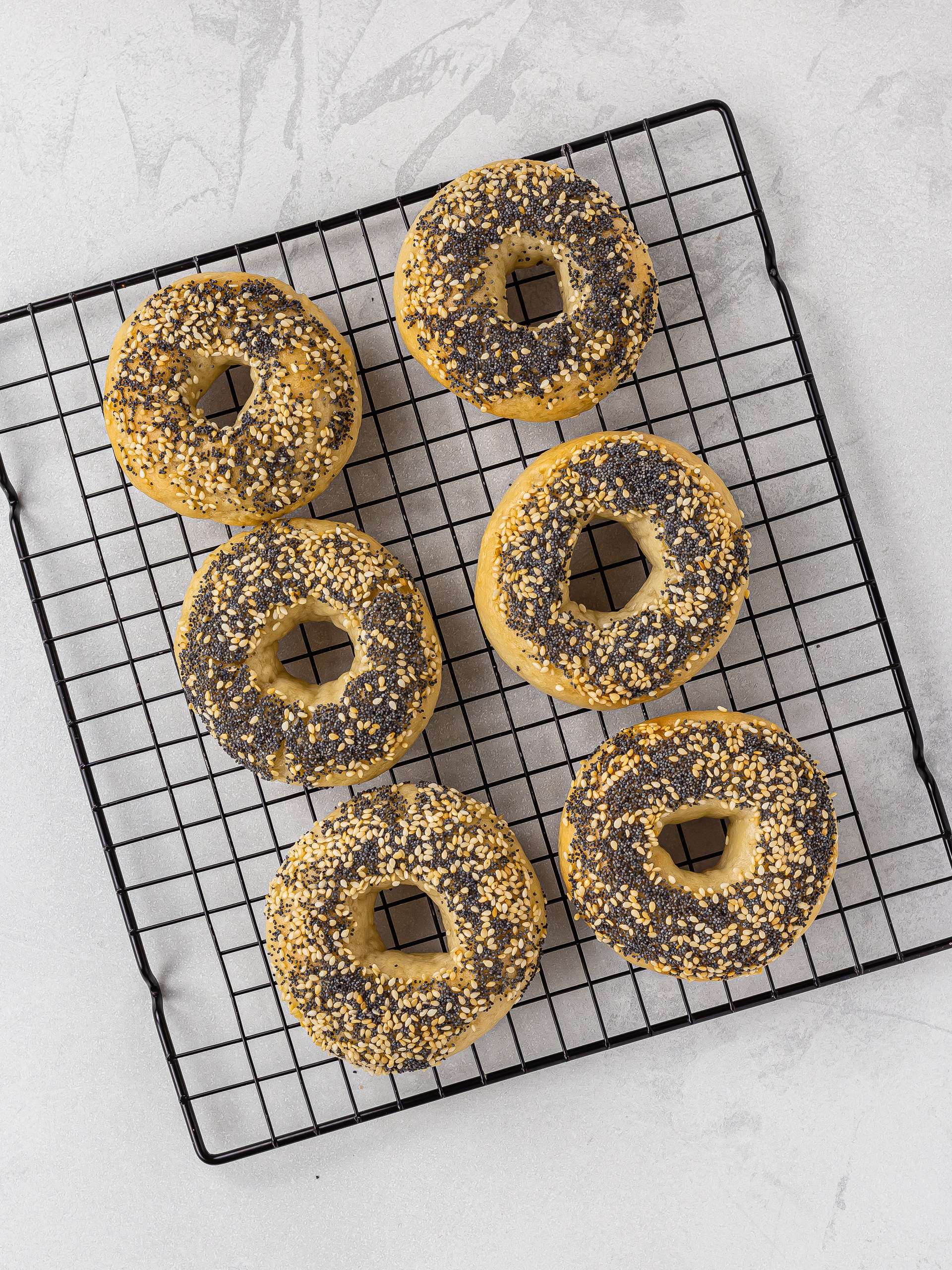 baked gluten free bagels on a rack