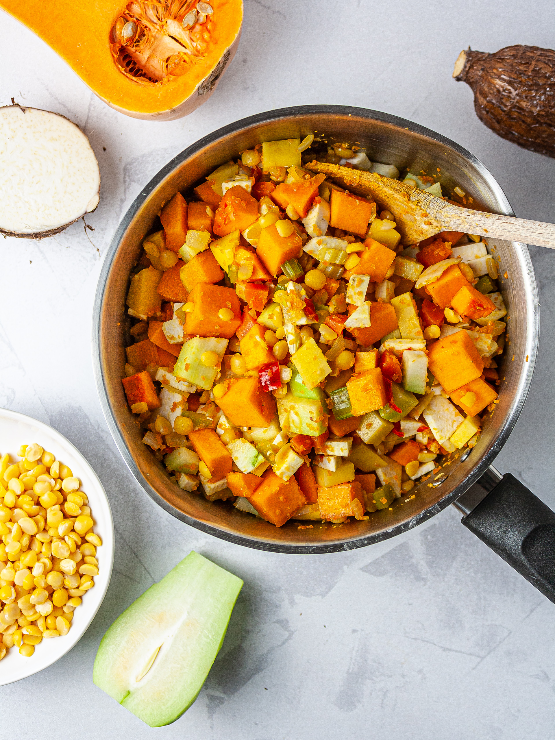 Jamaican vegetables on pot, including cassava, eddoes, chayote, and pumpkin.