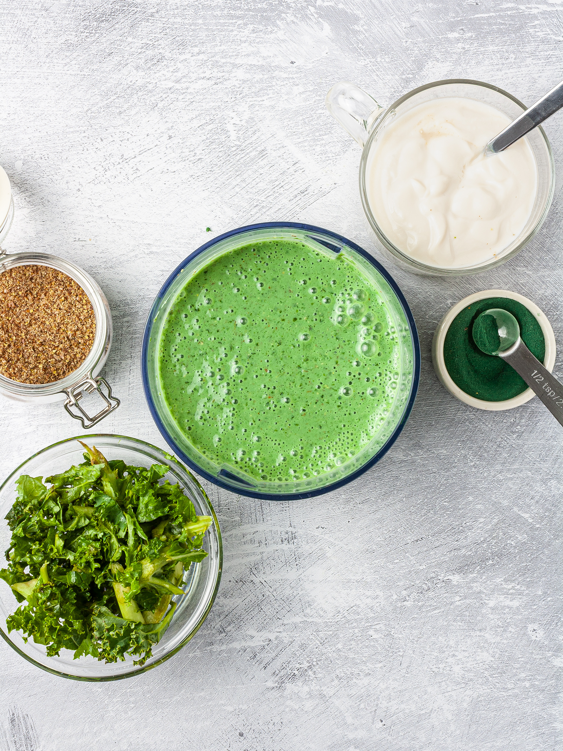 Kale shake mixed with spirulina, flax seeds, soy yogurt in a food processor. 