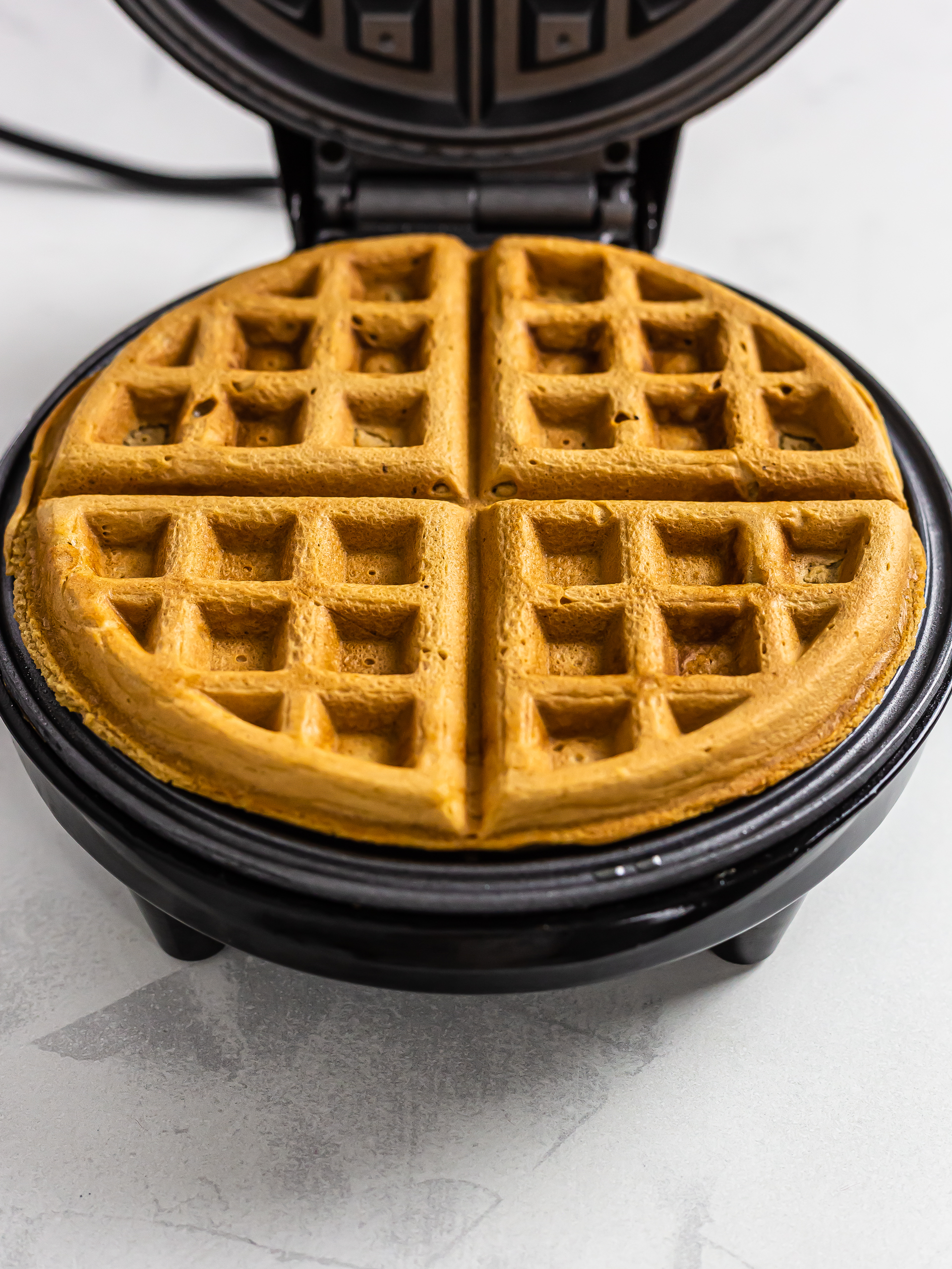 cooked biscoff waffles in a waffle machine