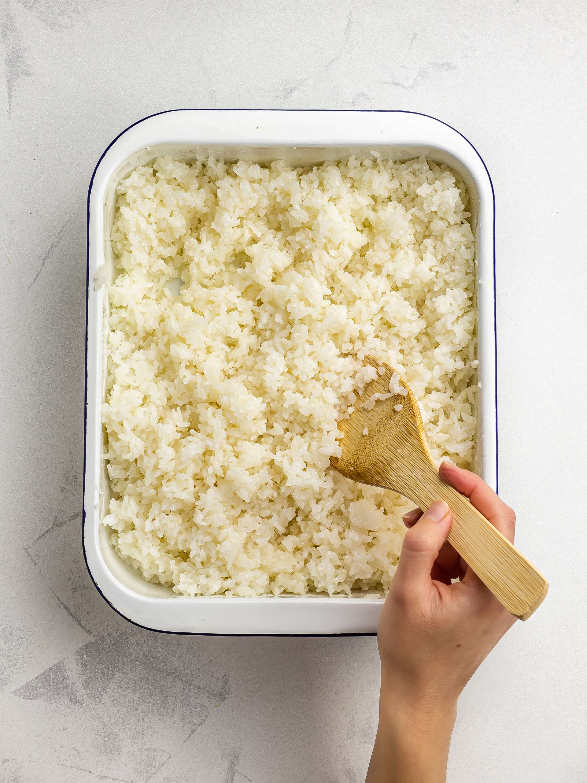 cooling down and fluffing sushi rice with a spatula