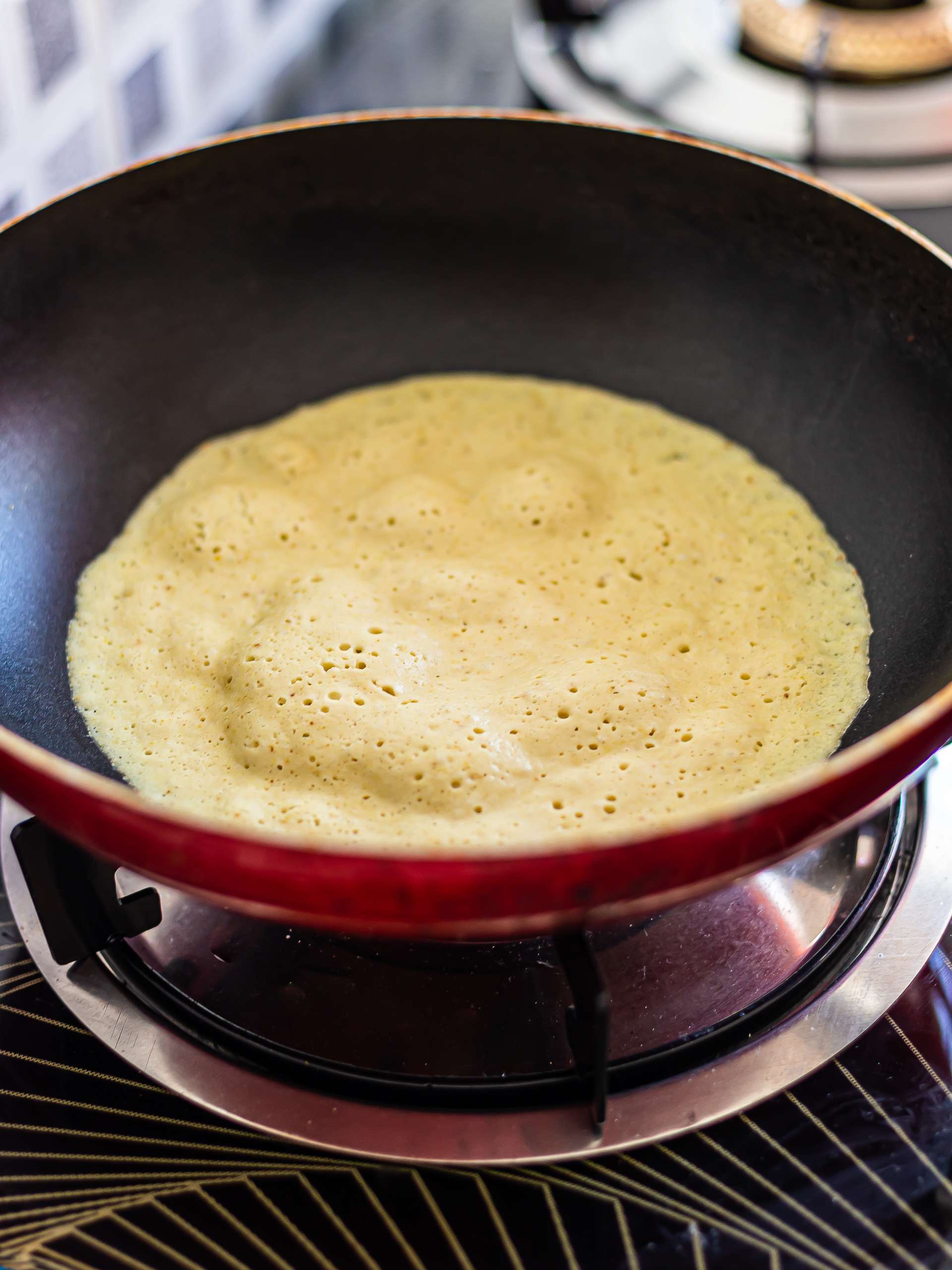vegan omelette cooking in a skillet