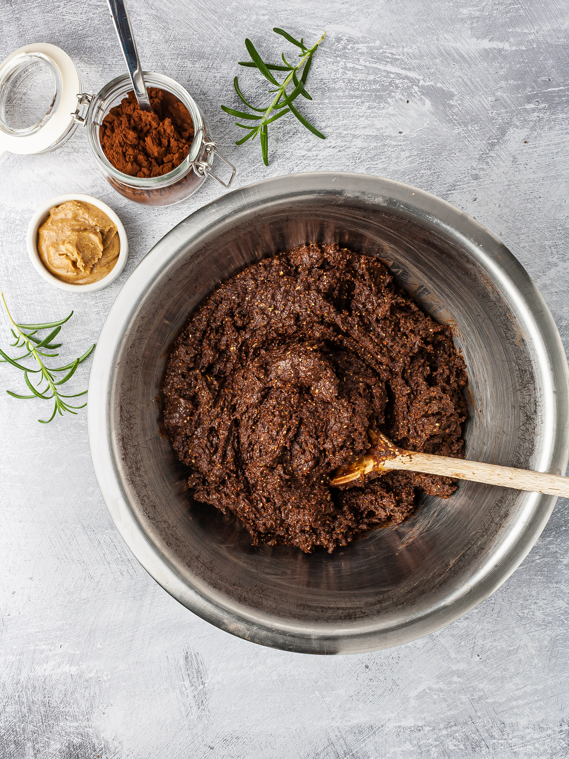 Brownies batter with almond butter, cacao, rosemary, dates, chia seeds, and oats.