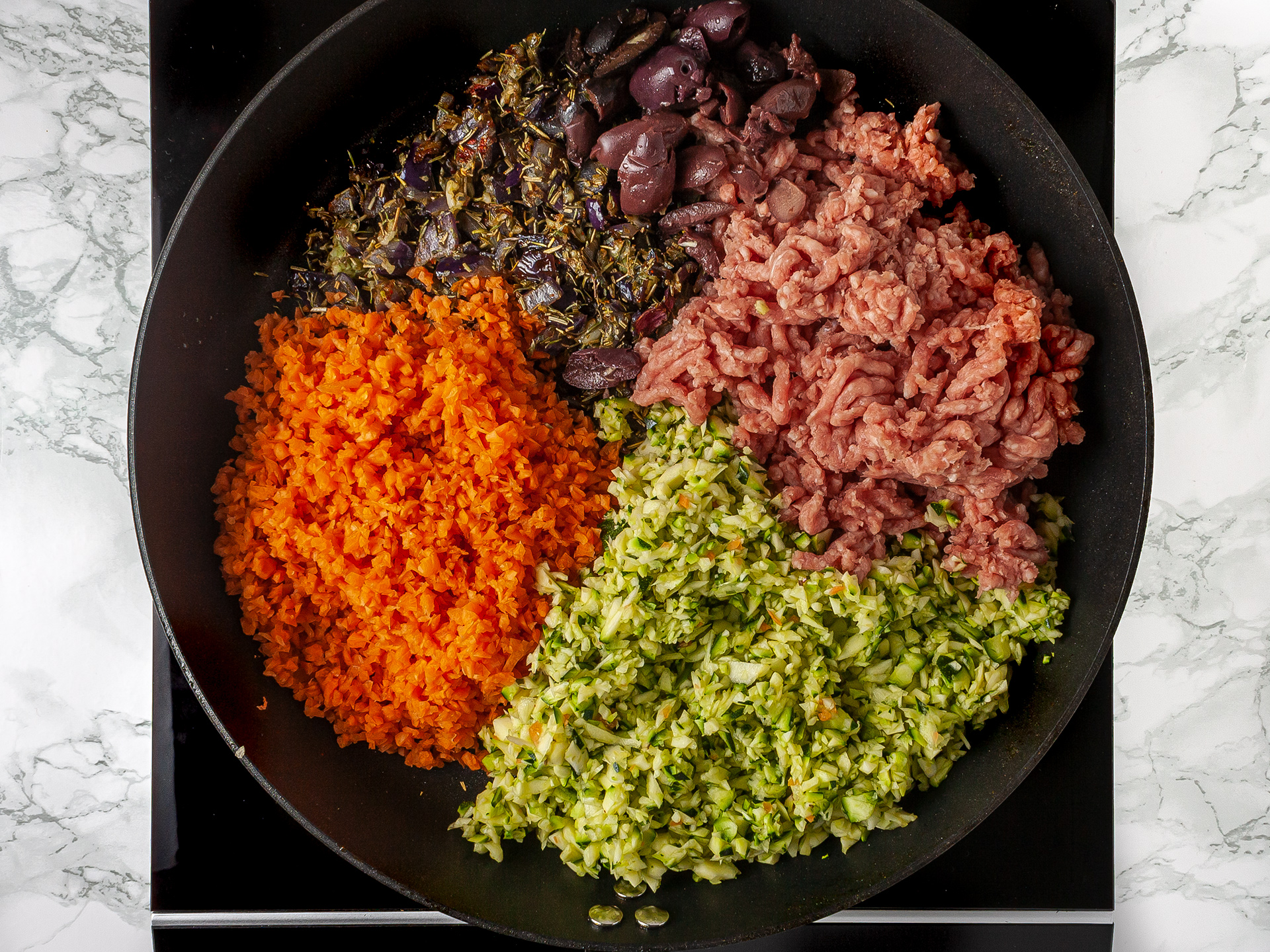 Lamb mince and grated vegetables in a skillet