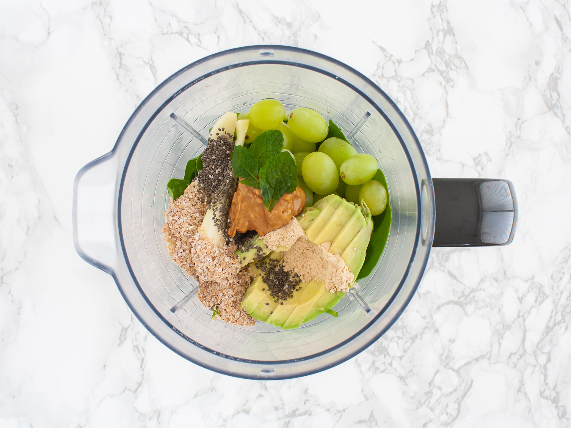 Chia seeds, nut butter, bran, and and mint in a food processor.