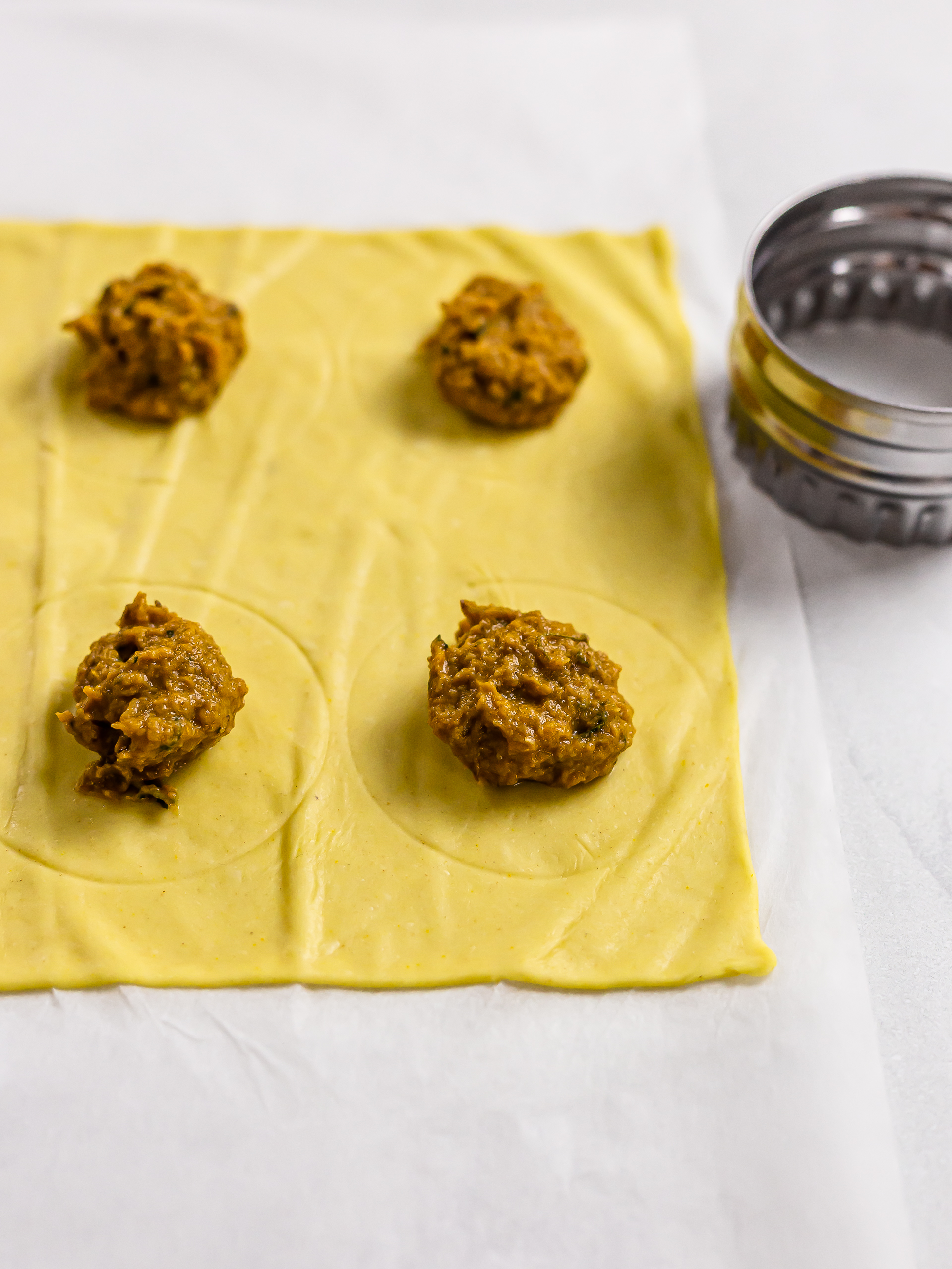 ravioli filling on a sheet of pasta dough