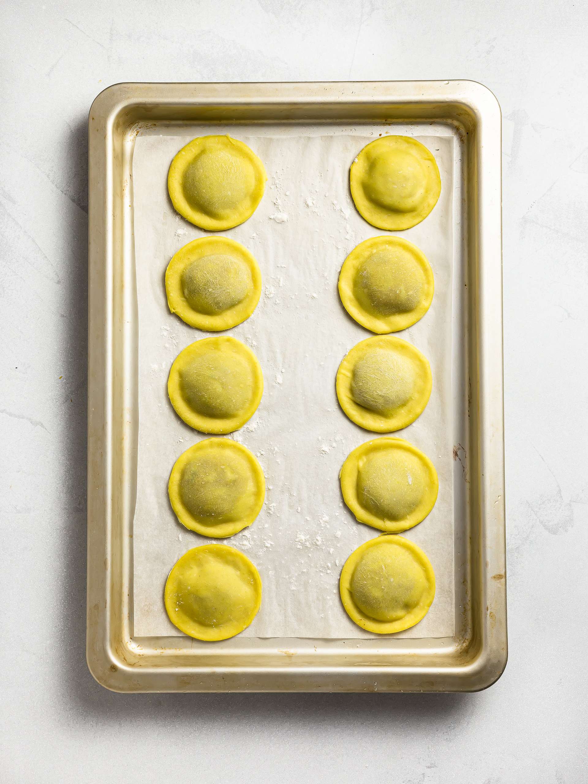 uncooked ravioli on a tray