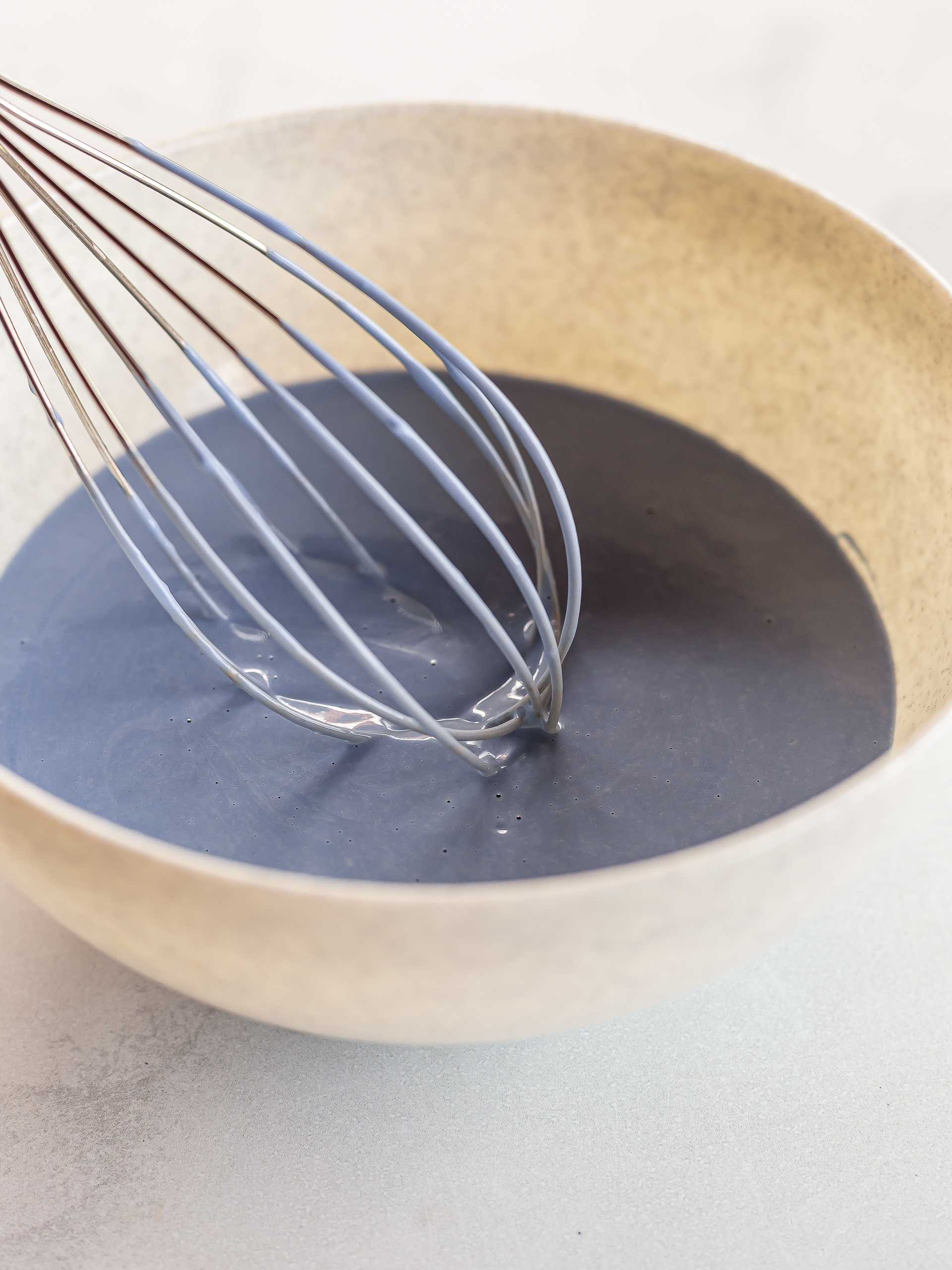 blue butterfly pea crepe batter in a bowl