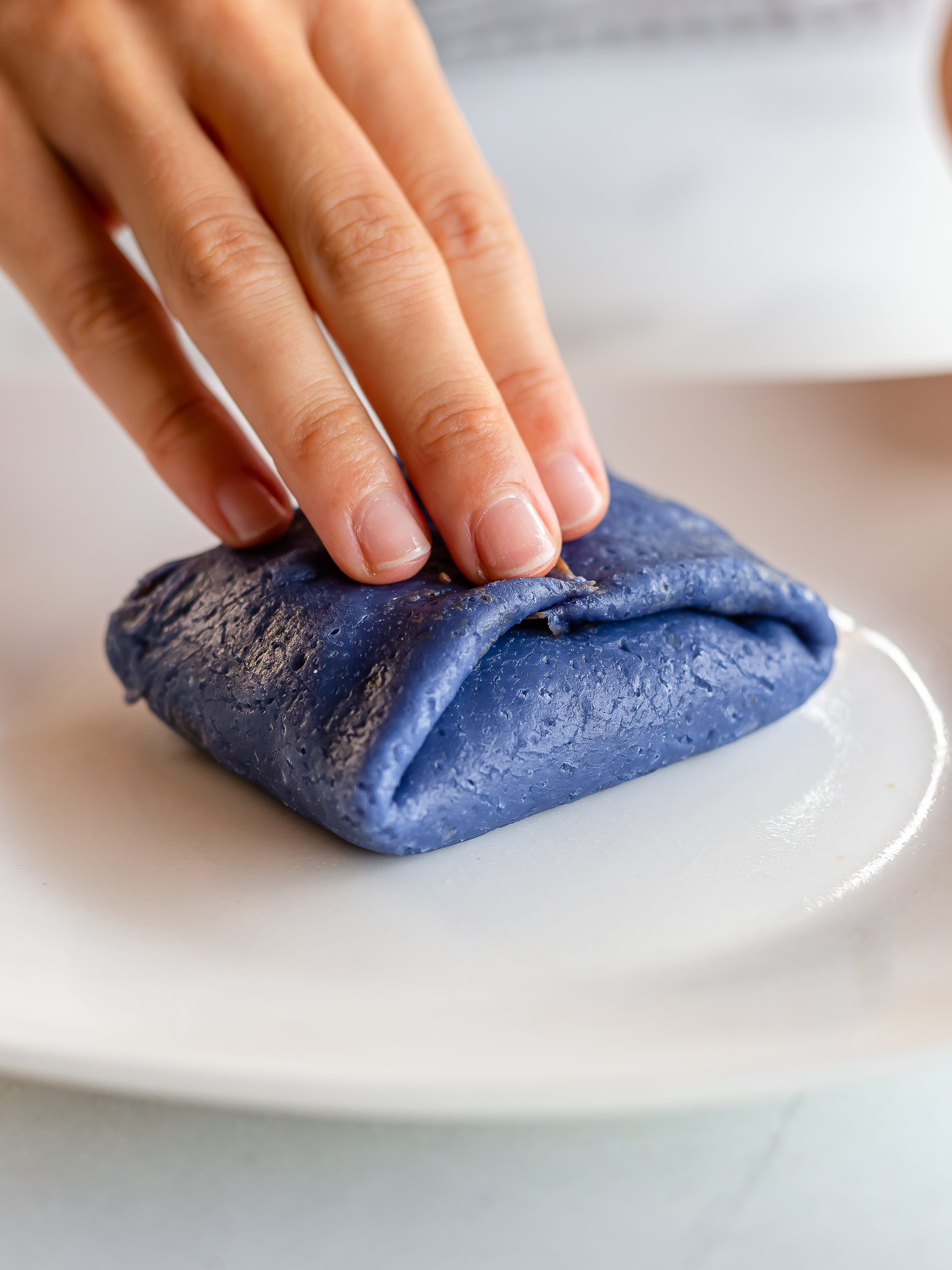 blue crepe folded into a pillow-shape with durian filling