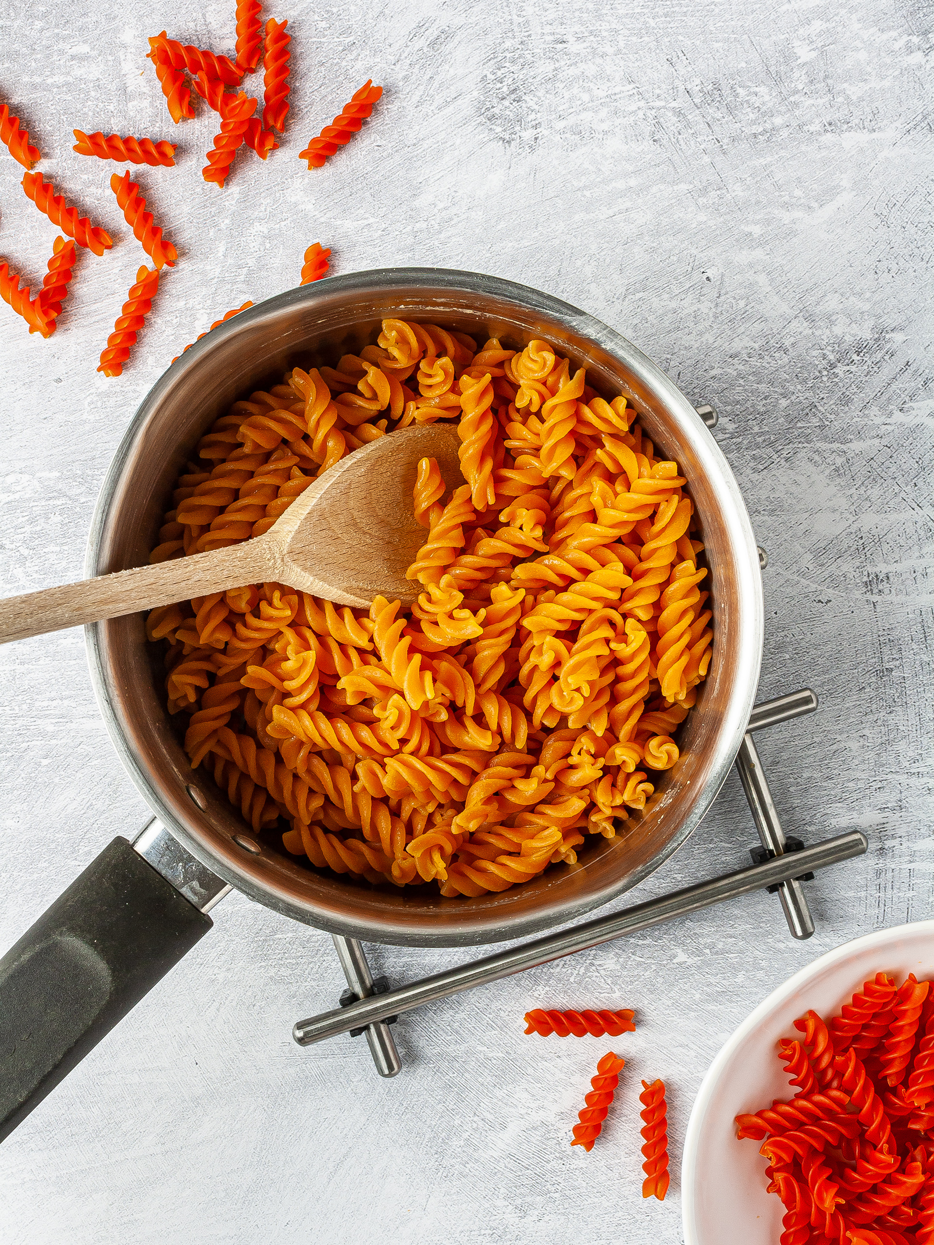 Dry and cooked red lentil pasta in a pot