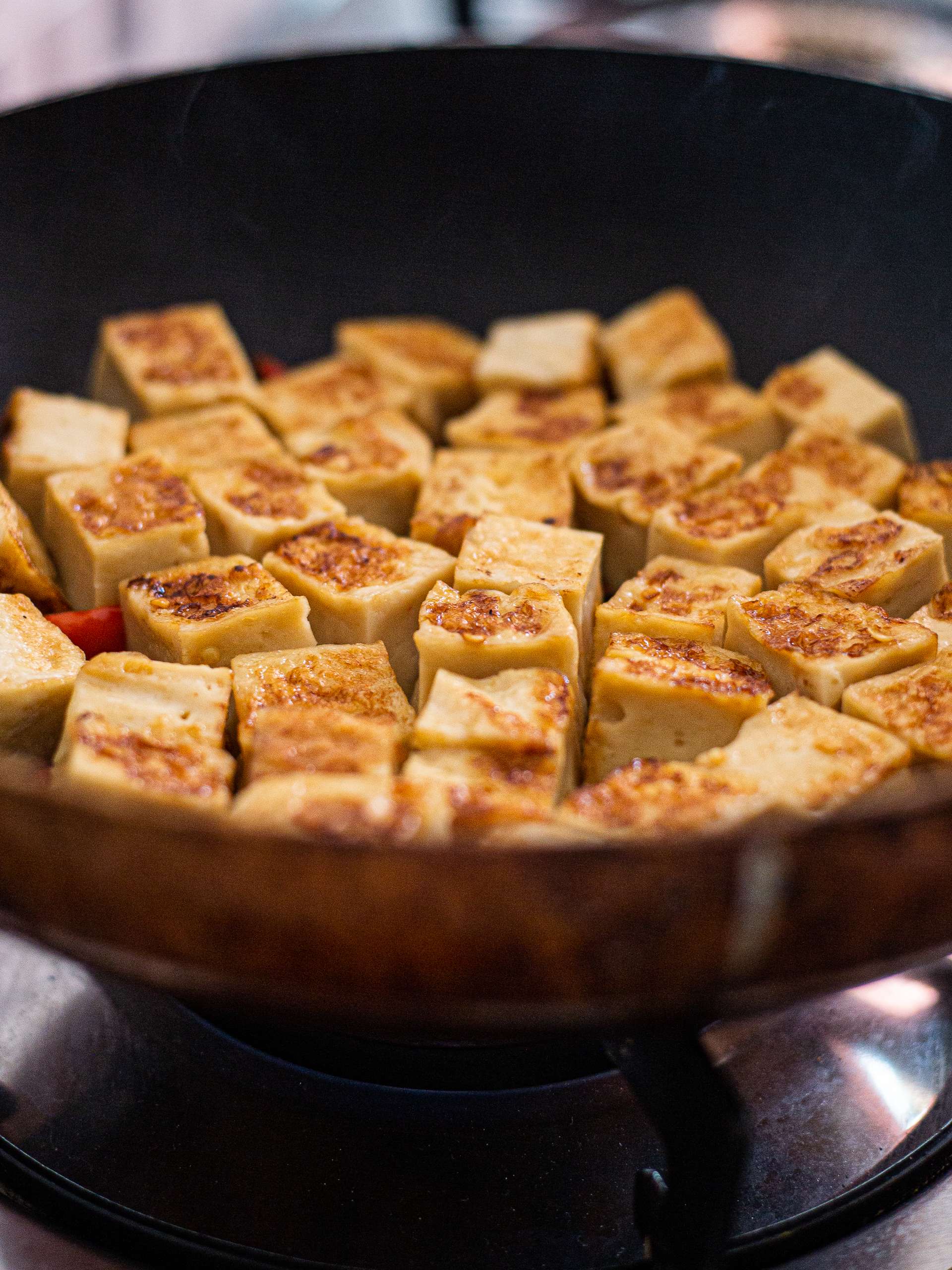 seared tofu cubes in a skillet
