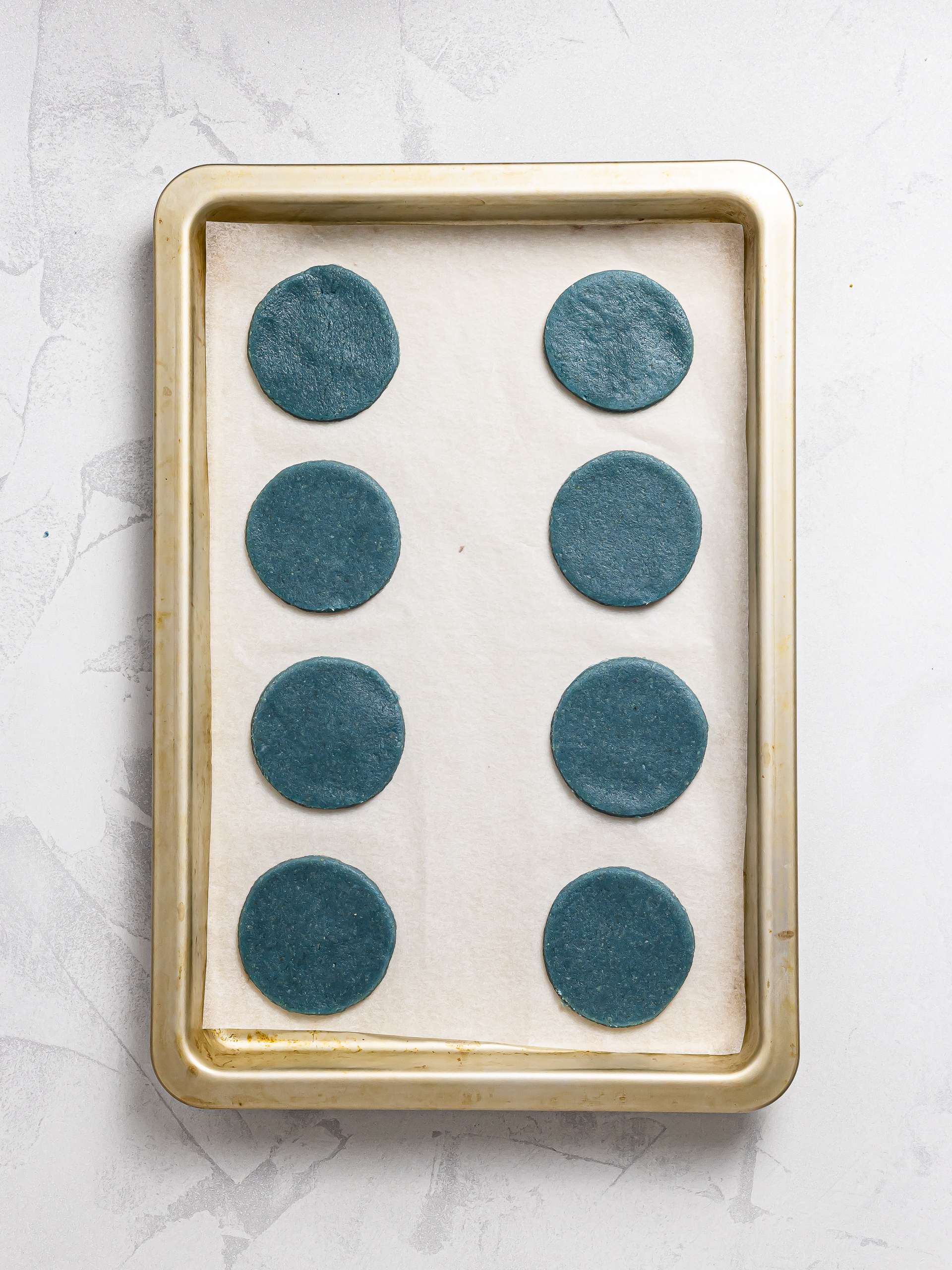 blue butterfly pea cookies on a baking tray