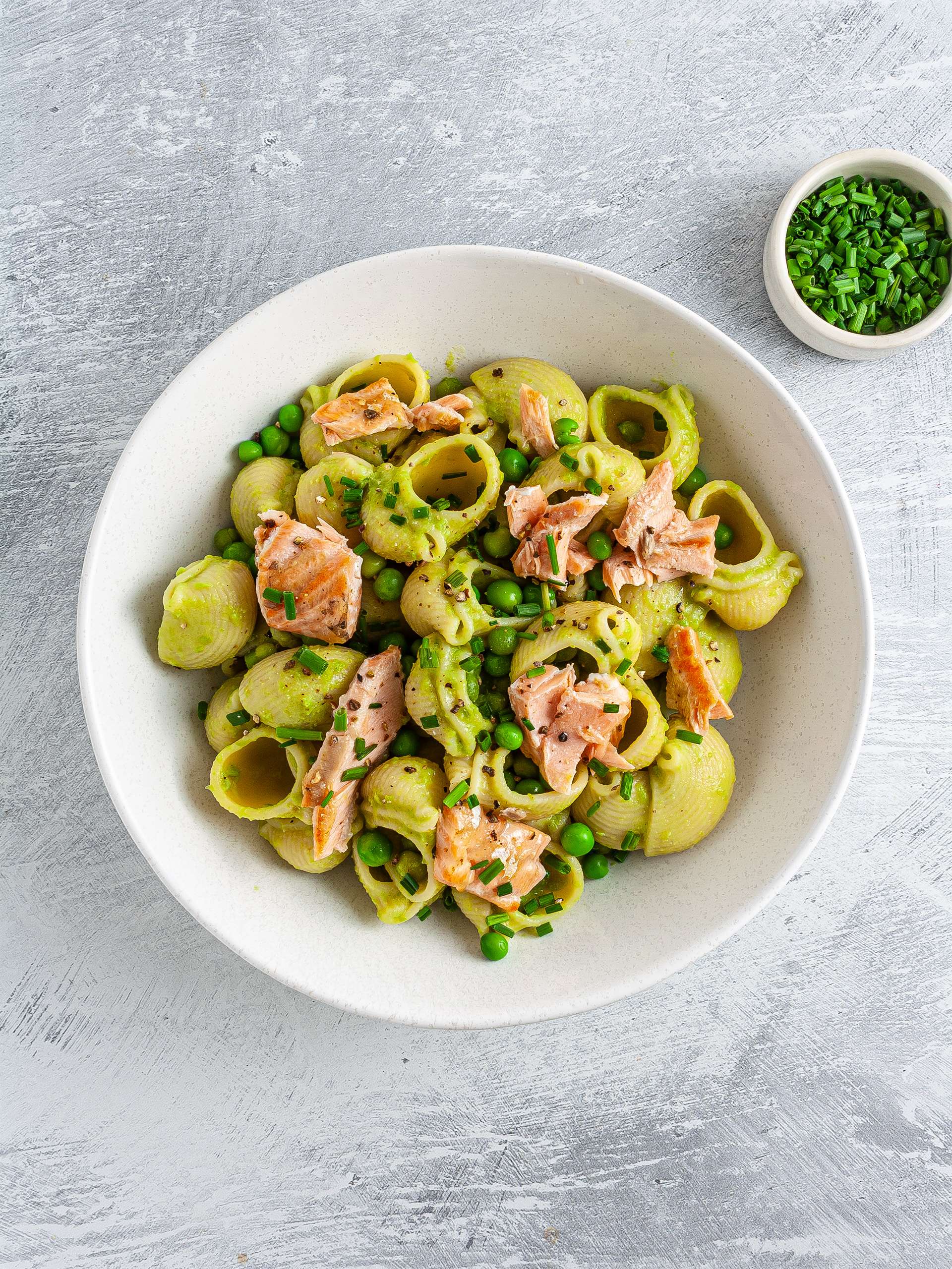 Salmon pasta salad with peas in a bowl
