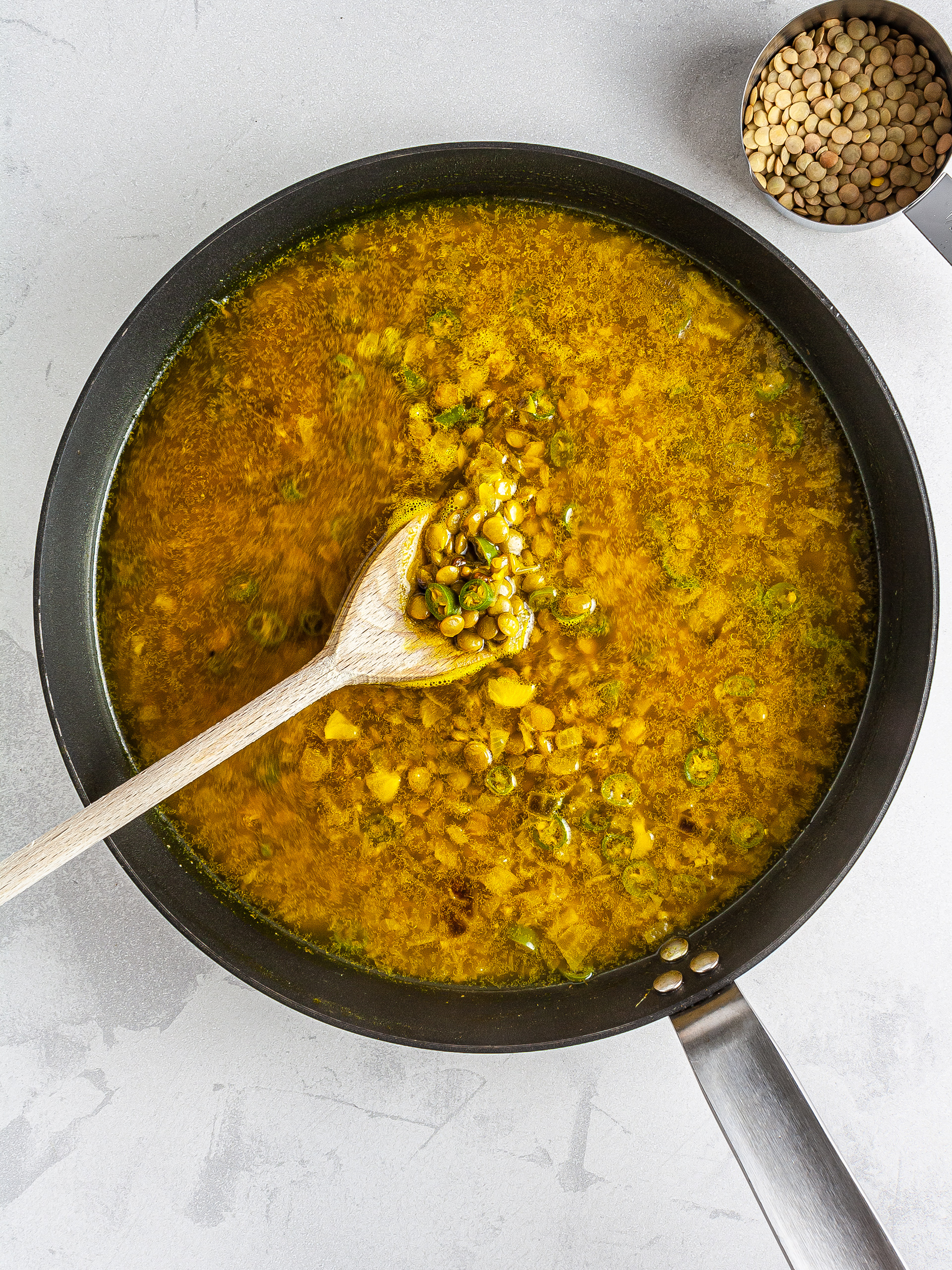 Lentils and turmeric broth in a skillet