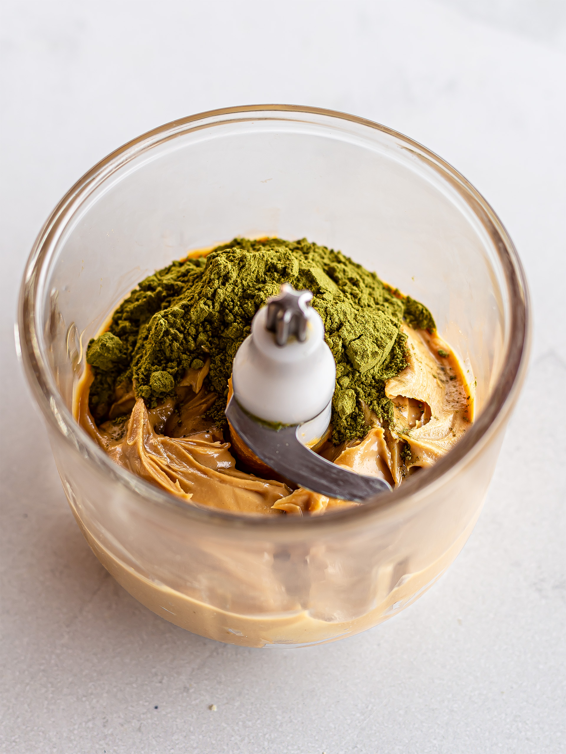 matcha powder and nut butter in a blender