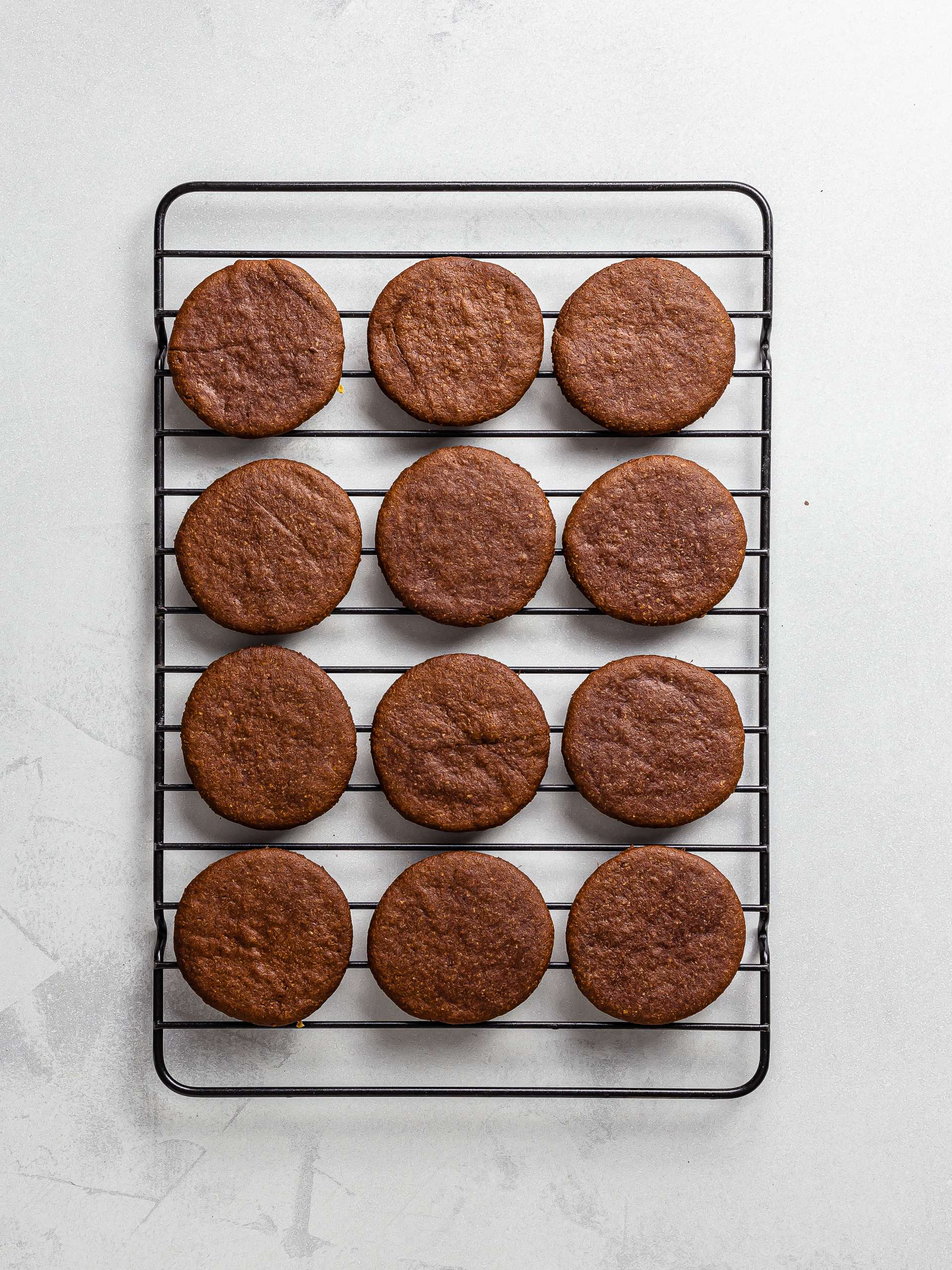 baked cocoa ube cookies on a rack