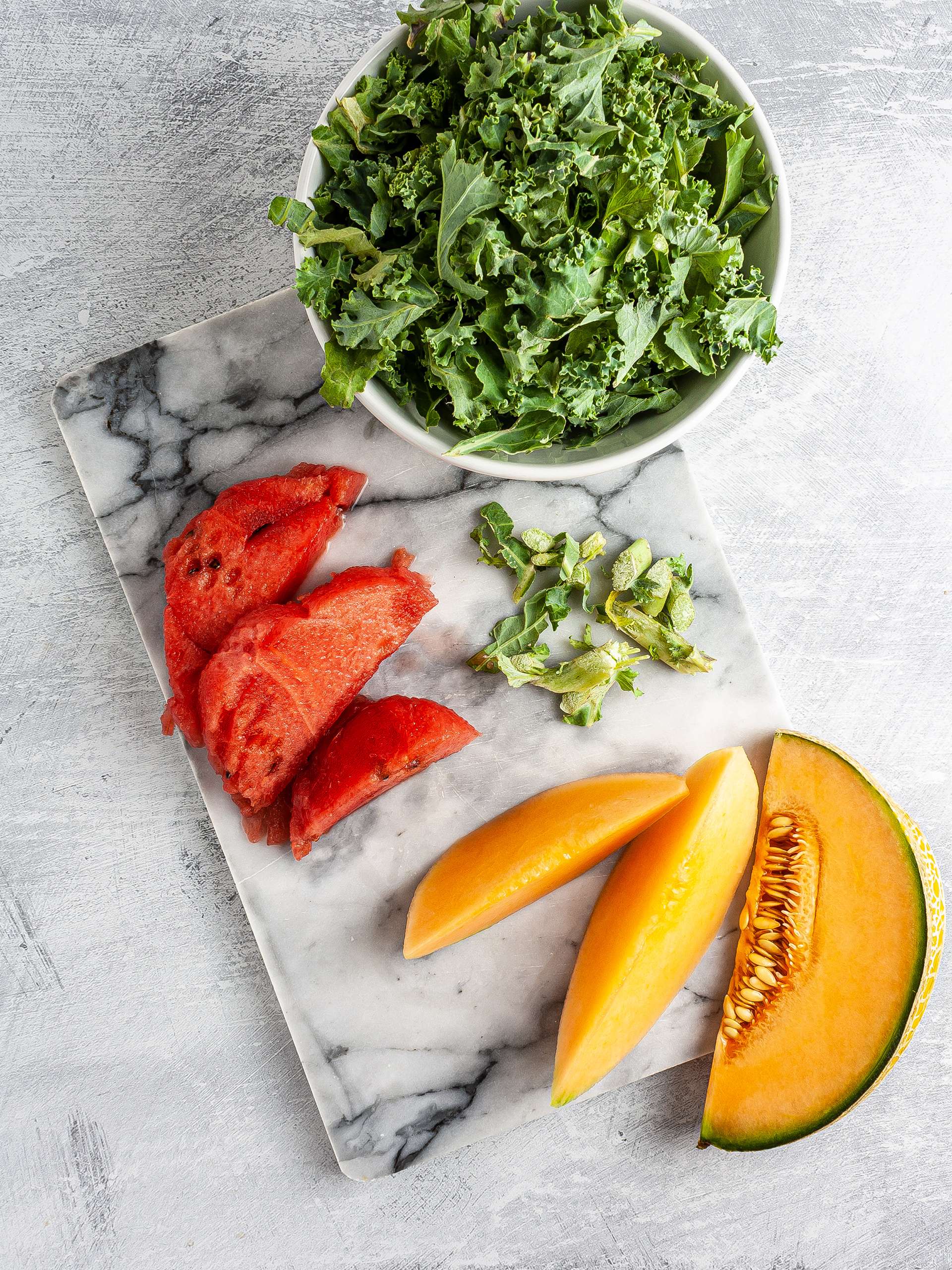 Shredded kale, sliced melon and watermelon