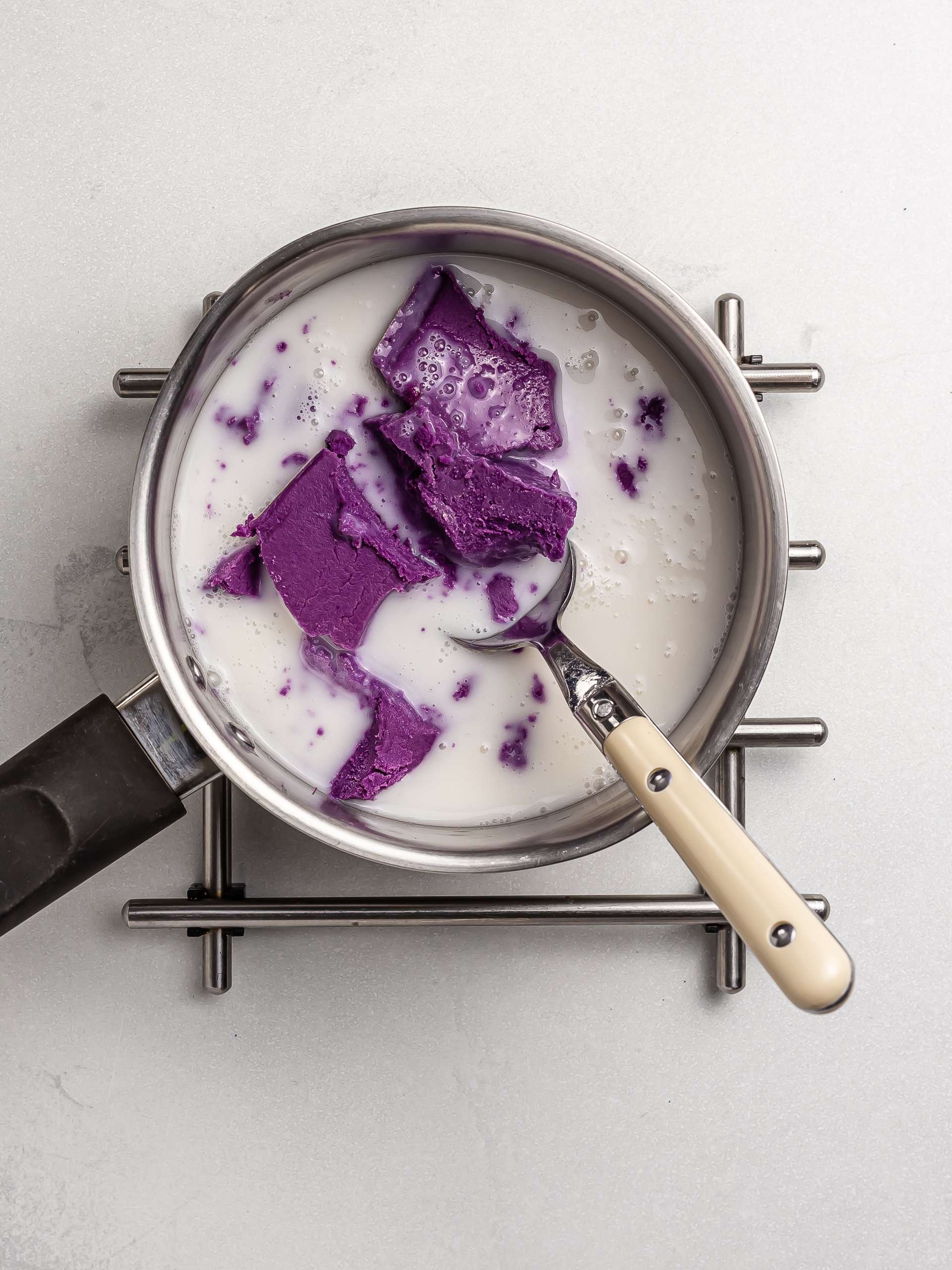 melting ube butter with milk in a pot