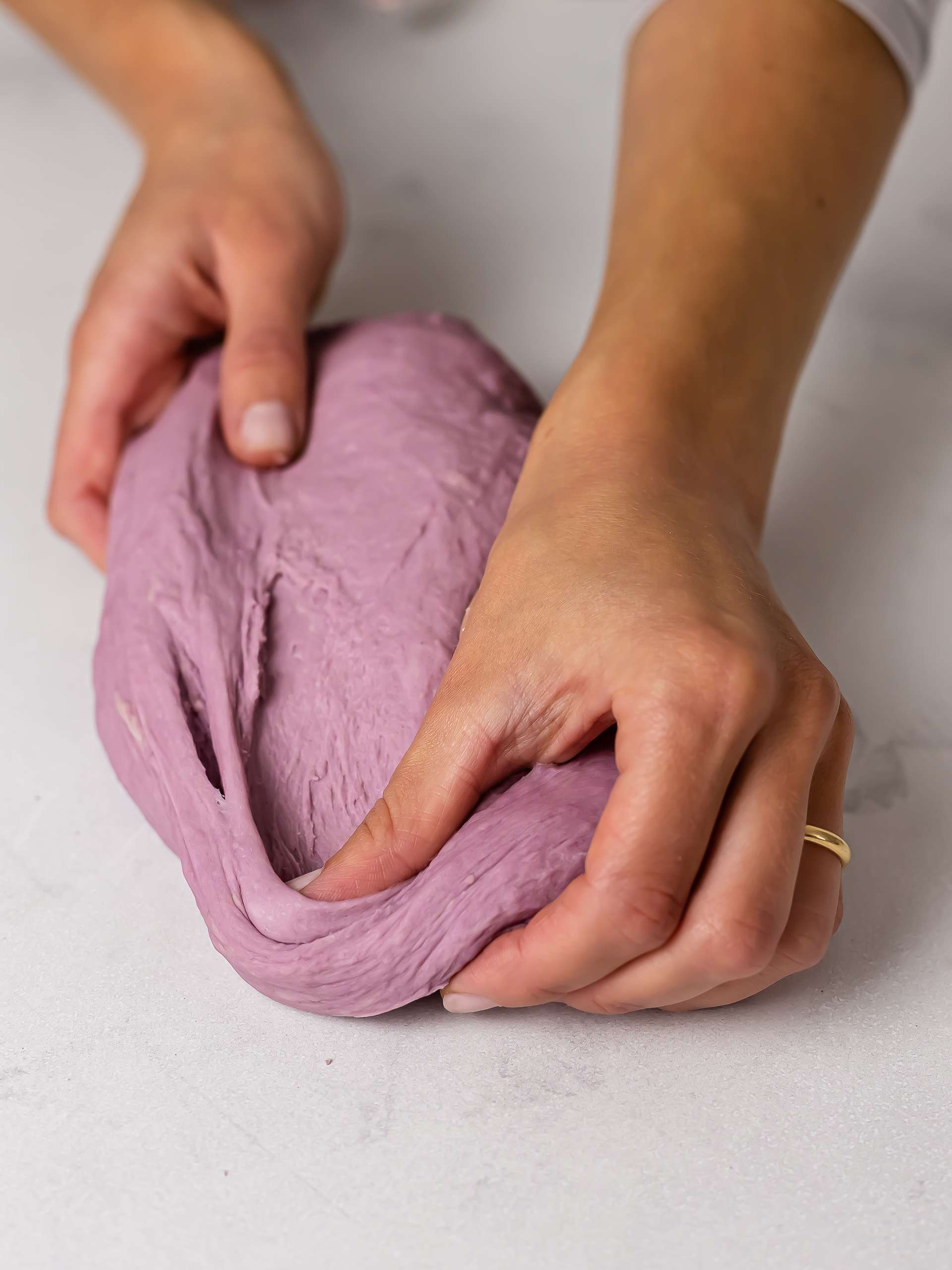 kneading purple ube donut dough