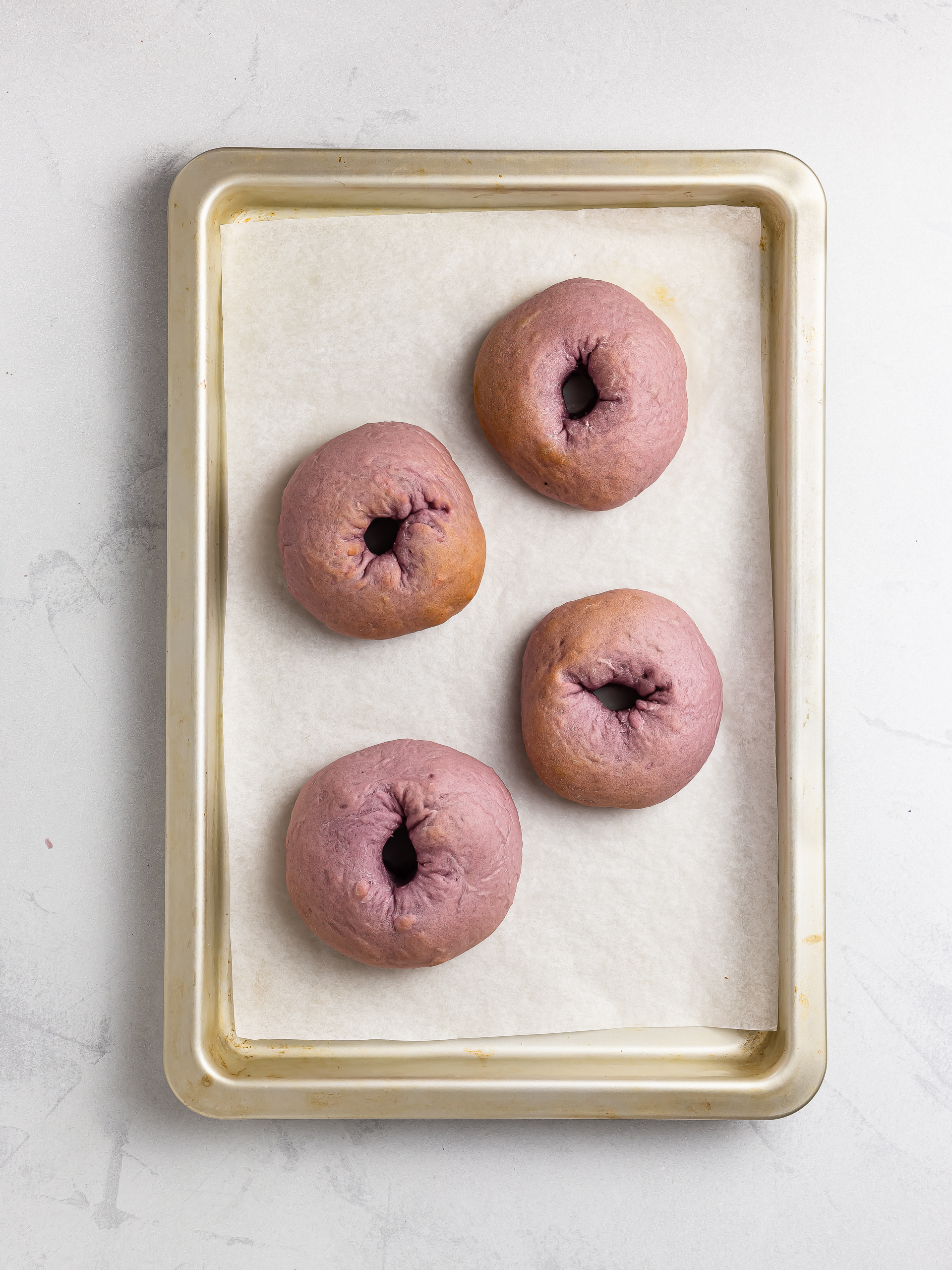 oven baked ube donuts on a tray