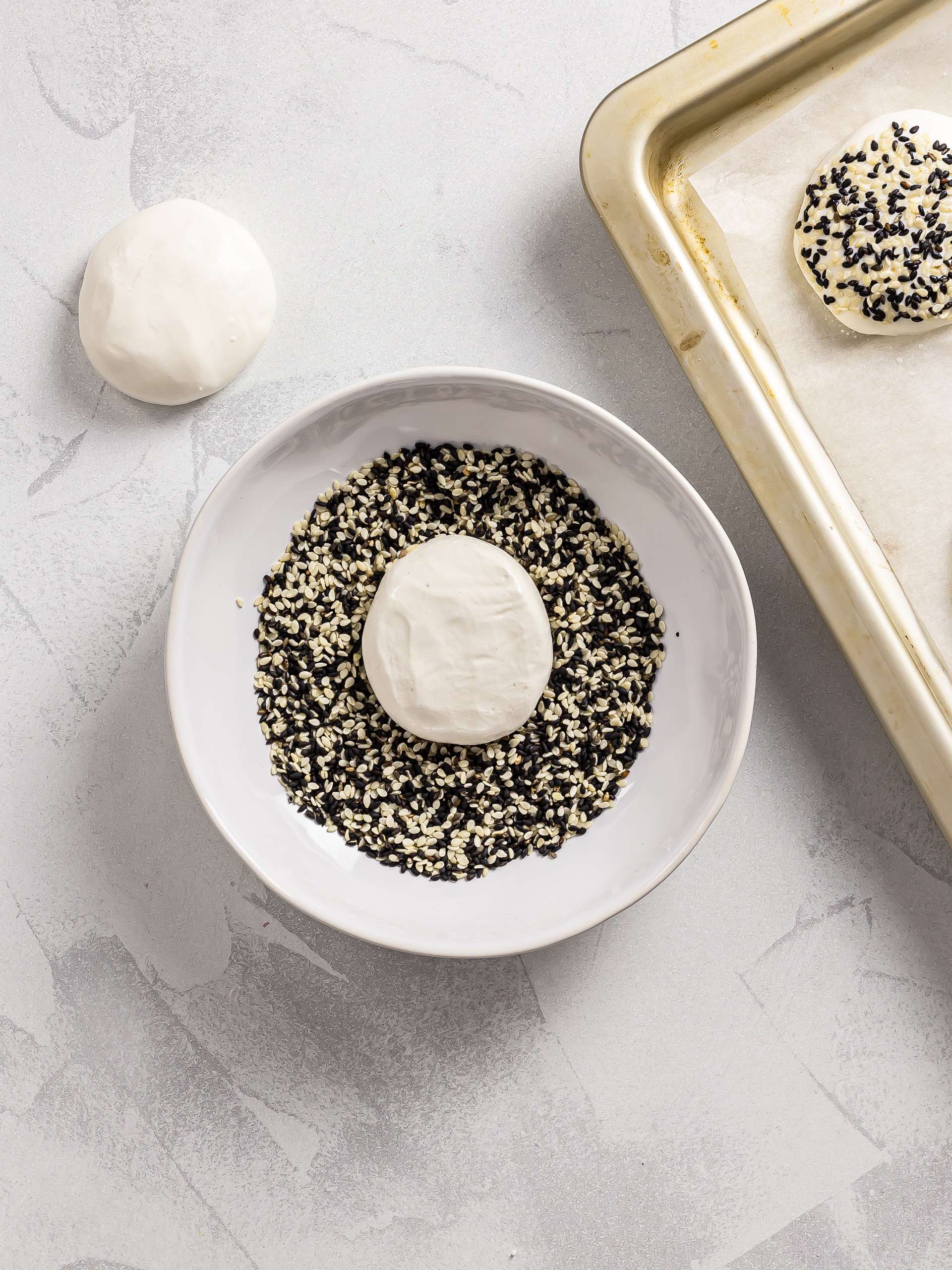 mochi bread rolls coated with black and white sesame seeds